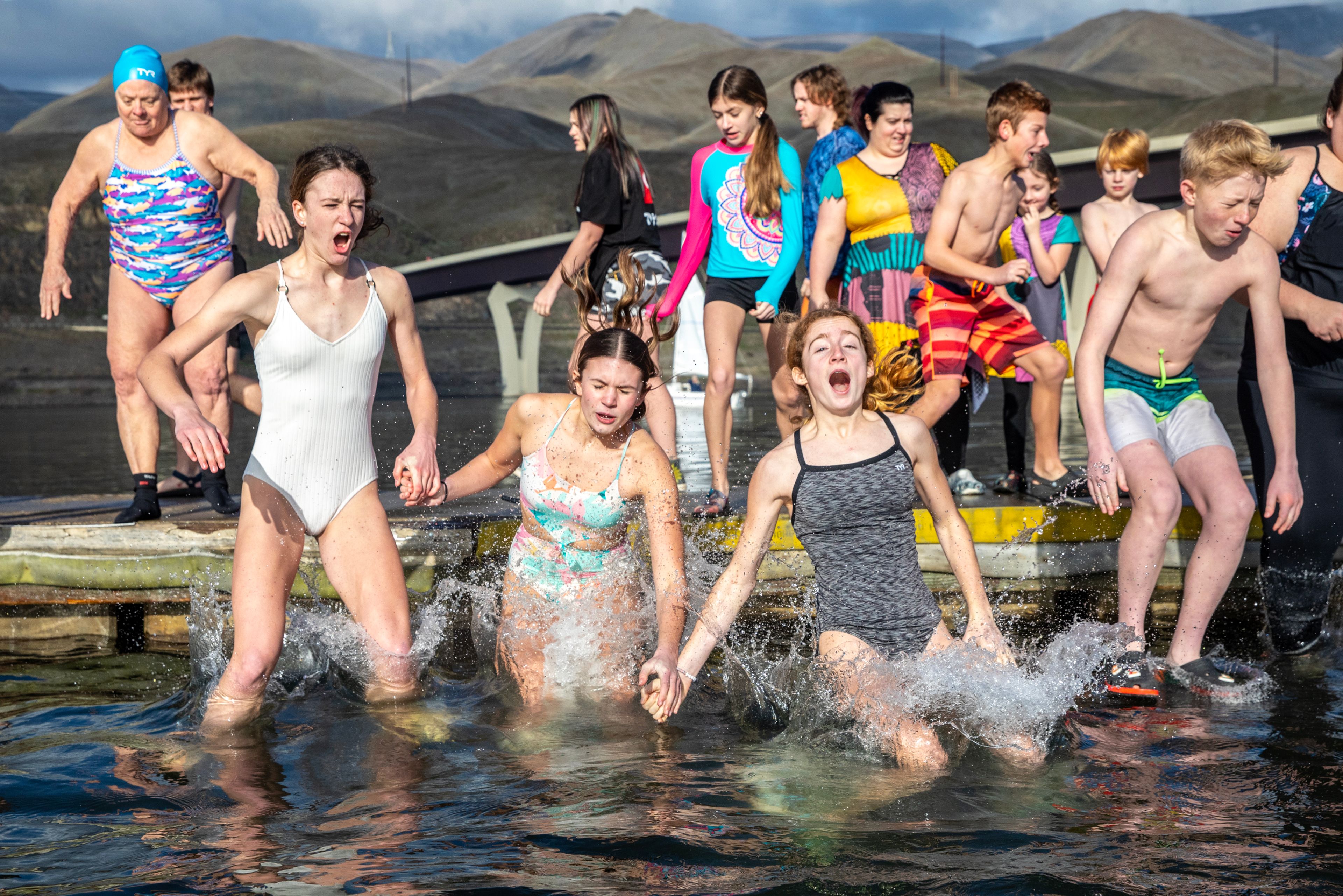 People react as they drop into the Snake River for the annual Polar Plunge Monday in Clarkston.