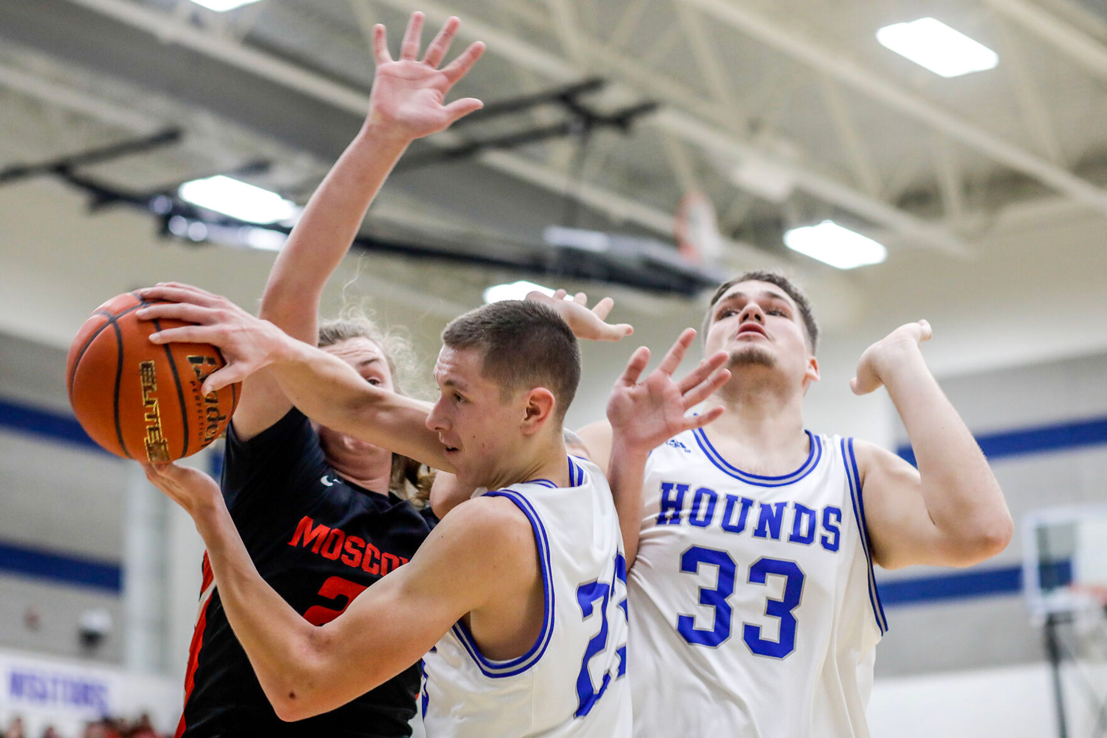 Pullman small forward Dane Sykes, center, comes down with the rebound during Saturday's nonleague boys basketball game.