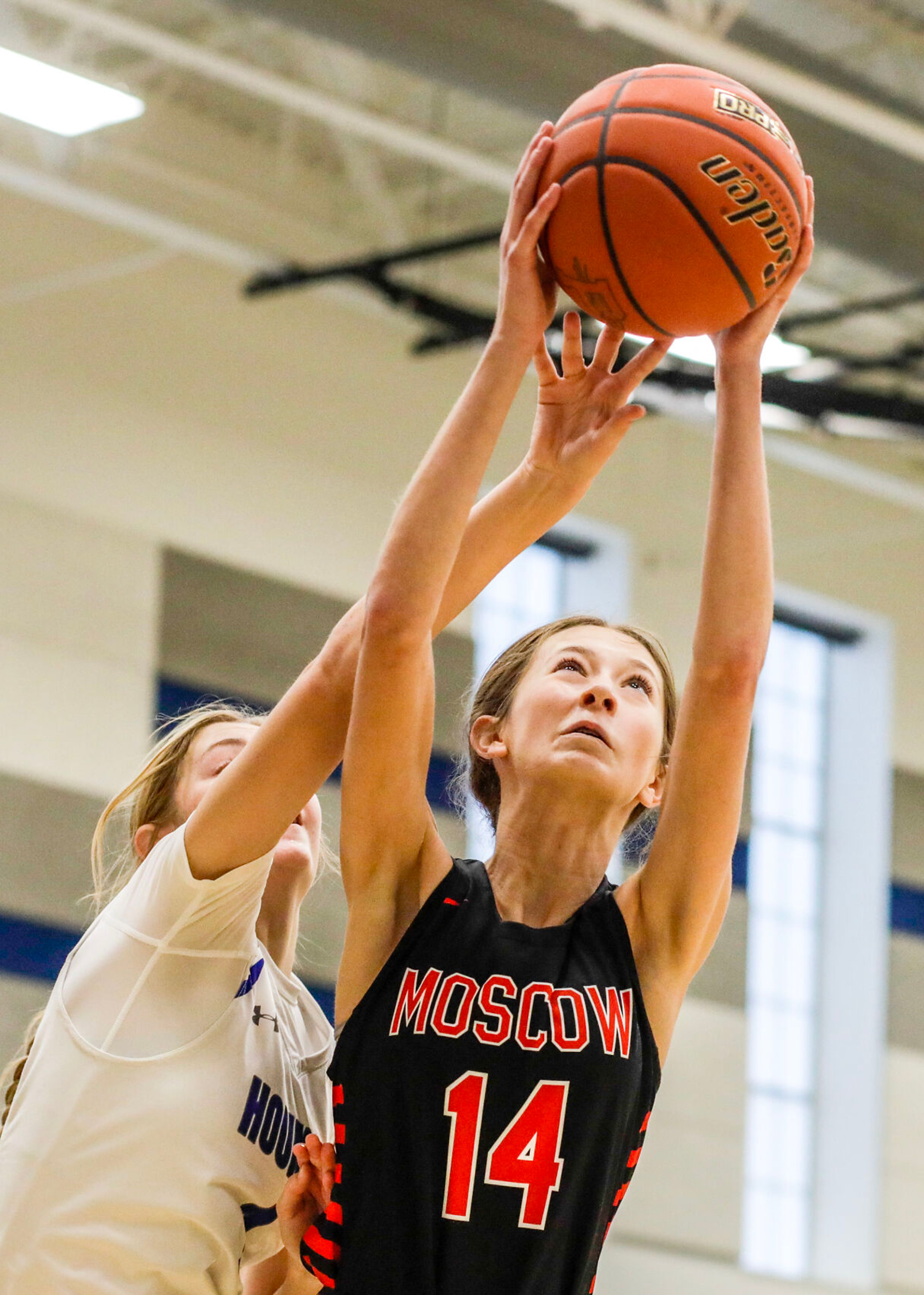 Moscow guard Taylor McLuen, right, grabs the rebound away from Pullman guard Megan Limburg during Saturday's nonleague girls basketball game.