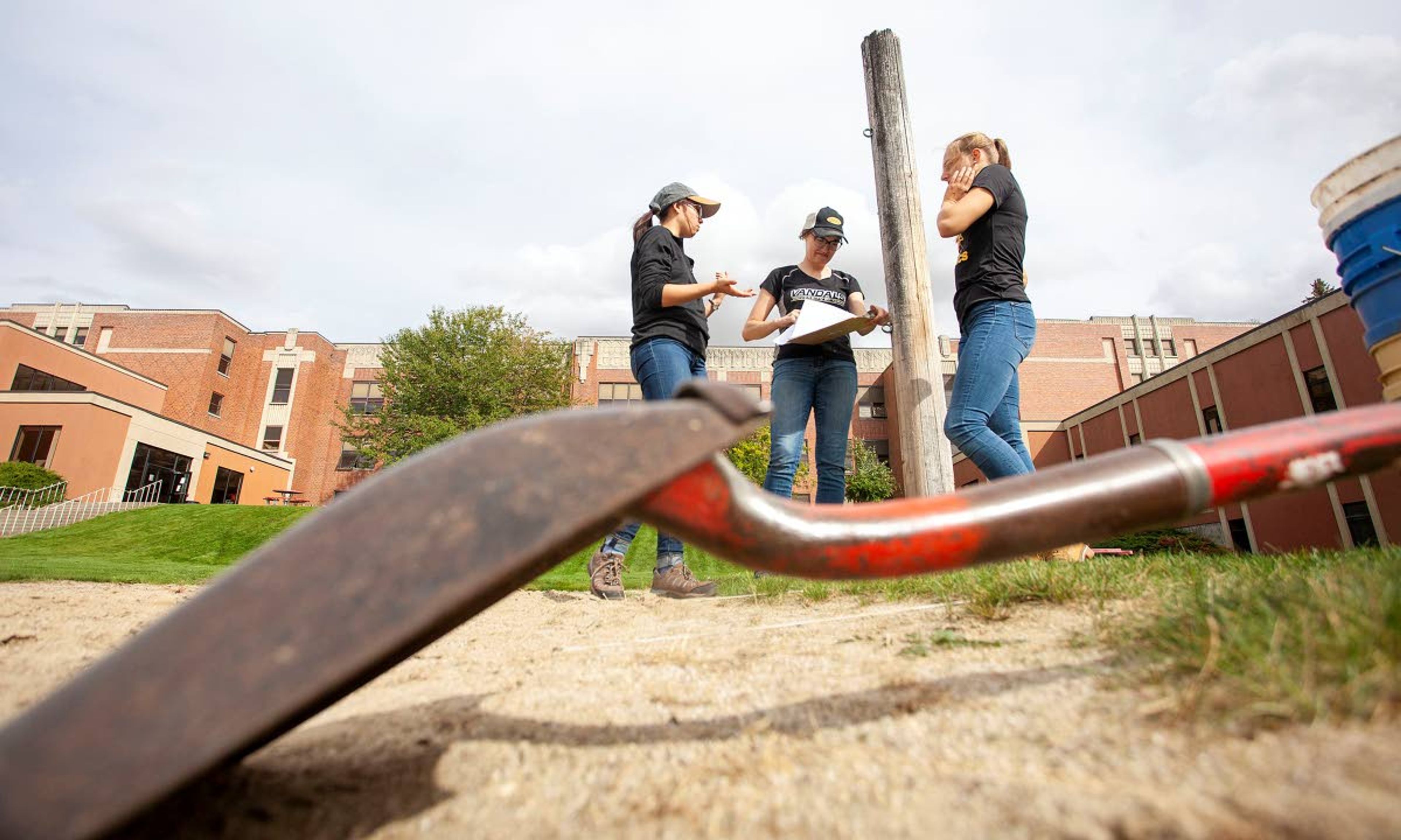 University of Idaho anthropology students Willow Elsom (left to right), Tessie Burningham and Henrike Fiedler set up an excavation unit at an archeological site Friday outside Moscow High School.