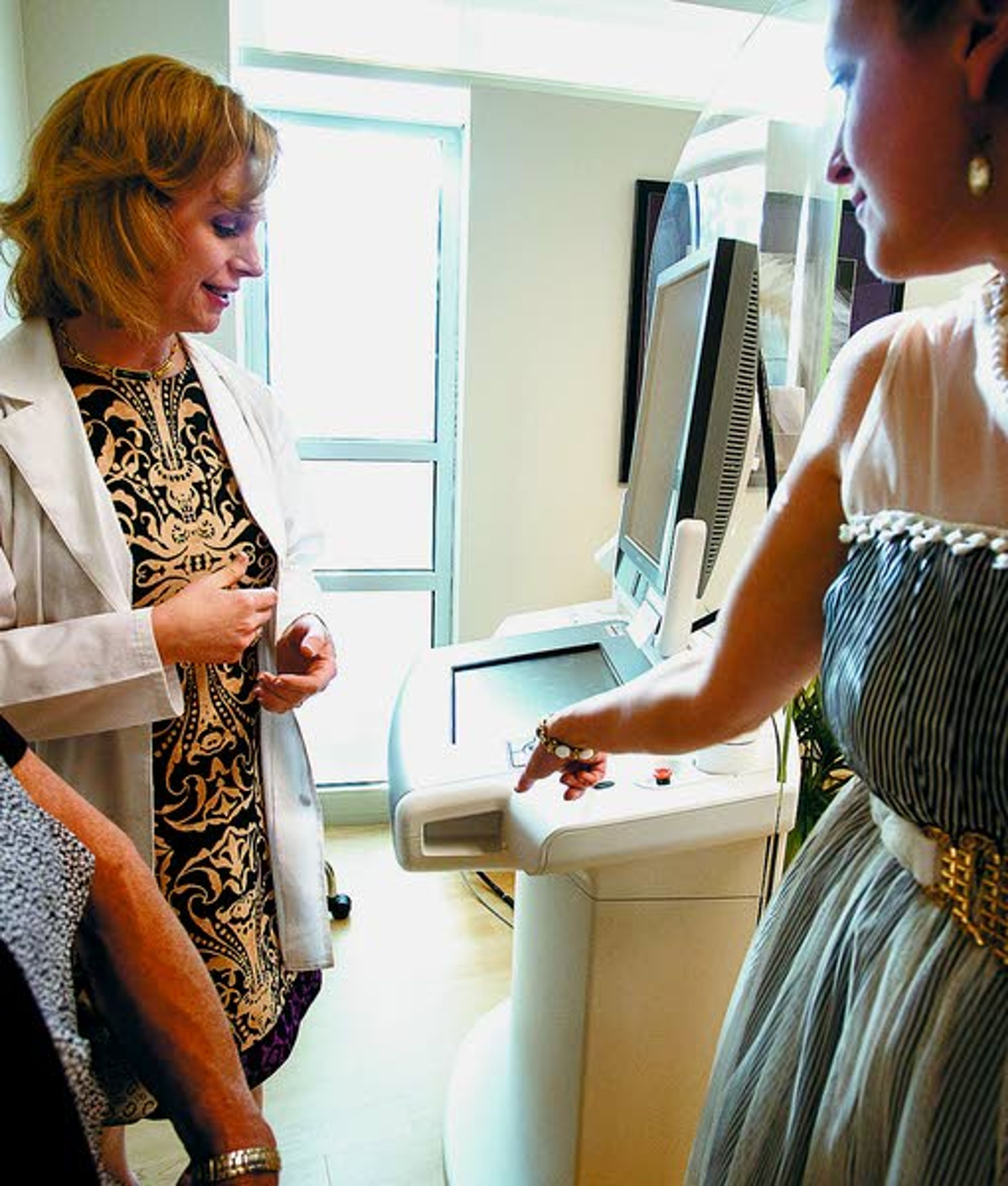 Radiologist Christin Reisenauer, center, watches as a radiologic technician places her finger on the biometric fingerprint reader to turn on the new 3-D mammogram machine Monday in the Women’s Center at Gritman Medical Center in Moscow. With this new mammogram machine, Gritman becomes the only local medical services provider in the area with this enhanced cancer-finding technology.