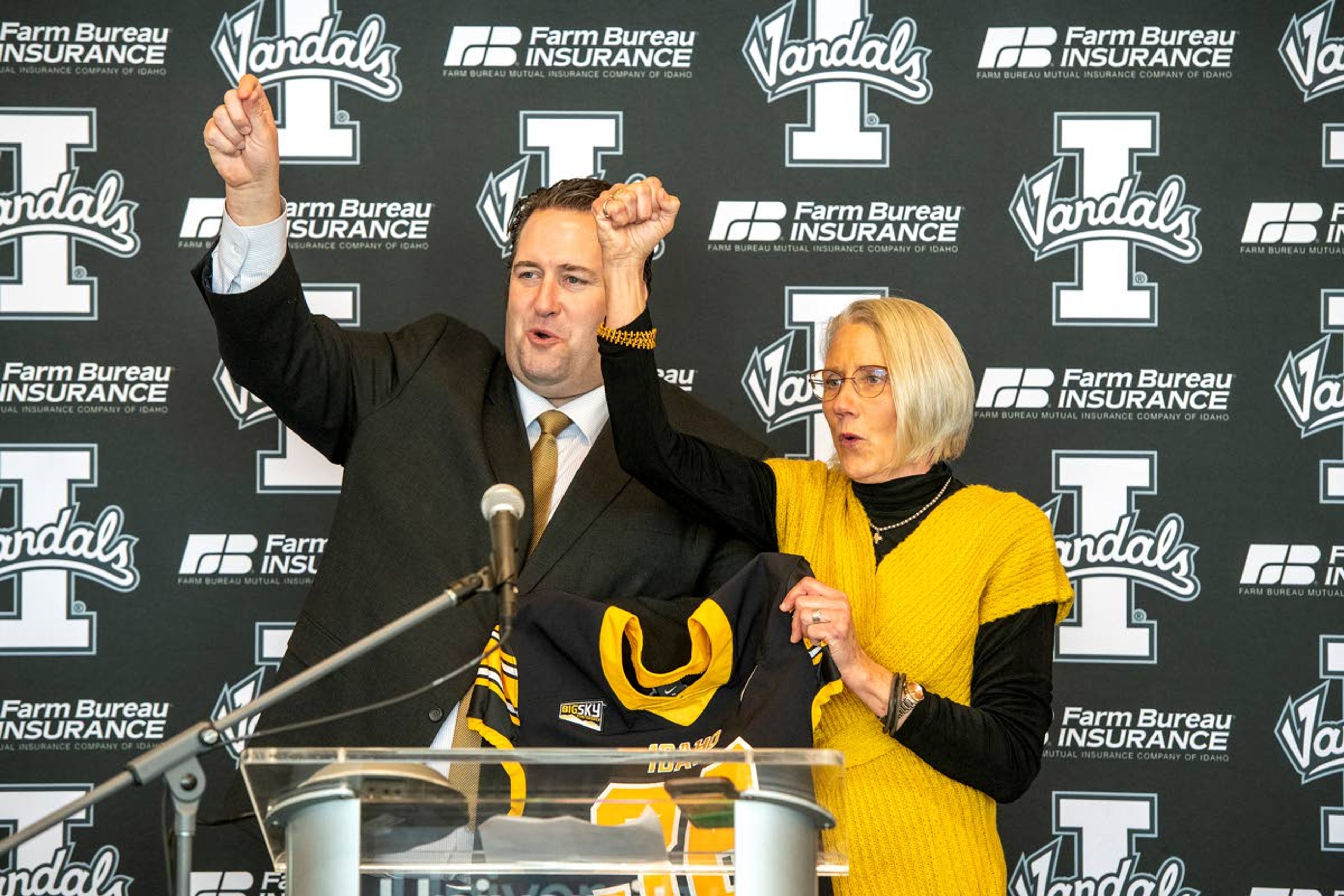 University of Idaho’s new head football coach Jason Eck joins Idaho athletic director Terry Gawlik in singing the Vandals’ fight song during an introductory news conference at Idaho Central Credit Union Arena on Monday afternoon in Moscow.