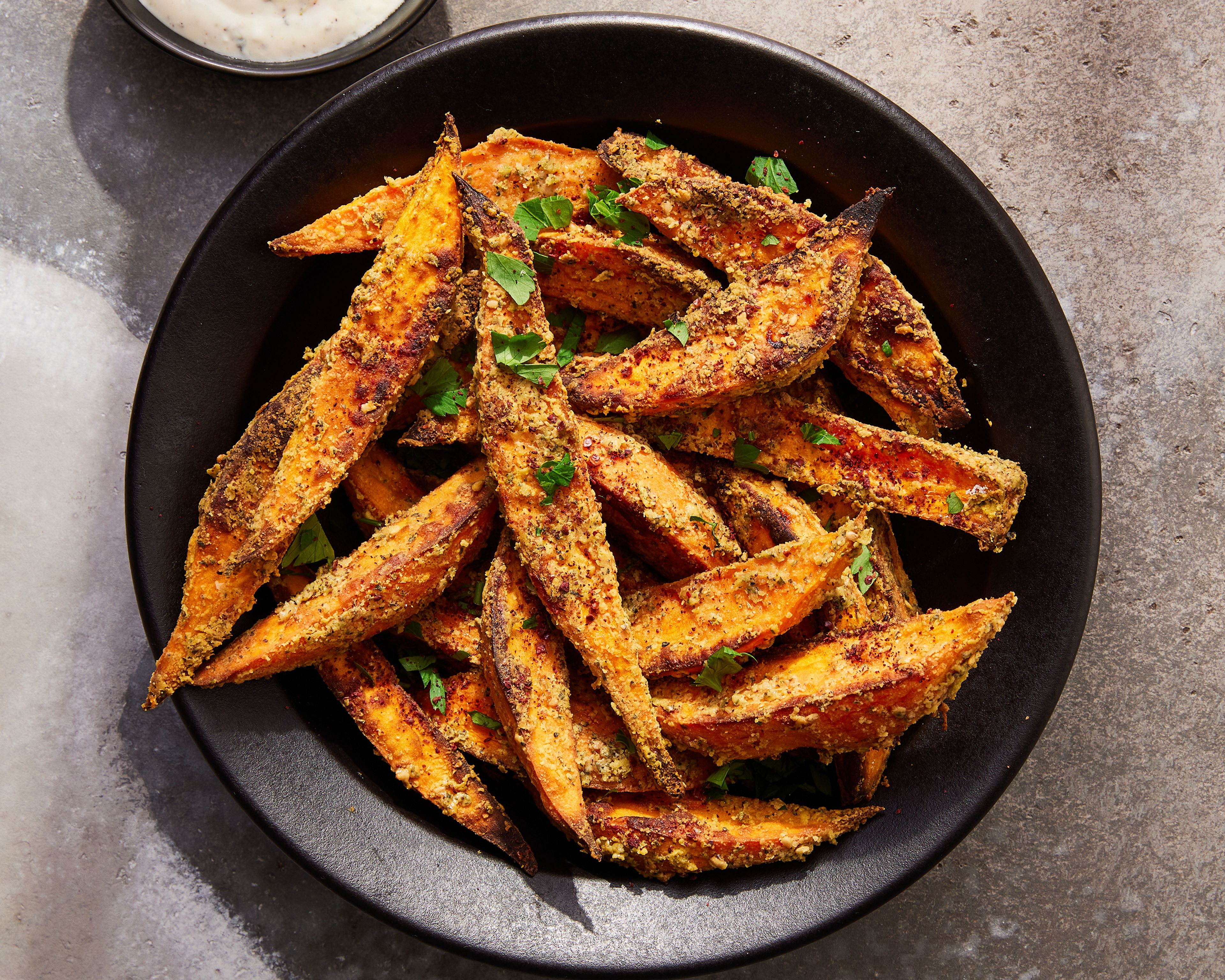 This image released by Milk Street shows a recipe for tahini-roasted sweet potatoes with za’atar (Milk Street via AP)