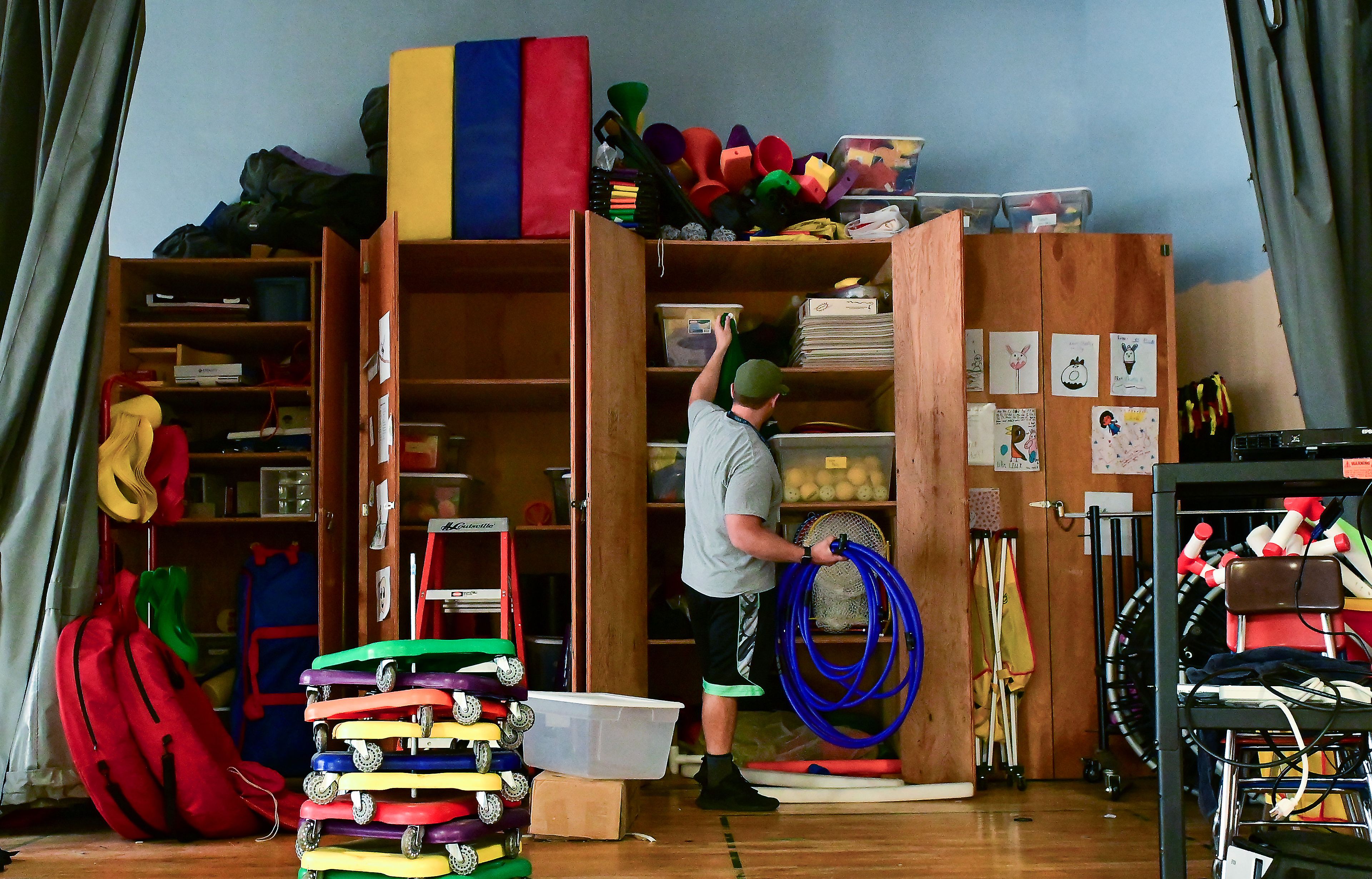 P.E. teacher Steve Gram works to clear out equipment from the Russell Elementary gym on Thursday after the last day of school the day before. Gram had traveled between Russell and West Park elementary schools, and will be based at West Park full-time next year.