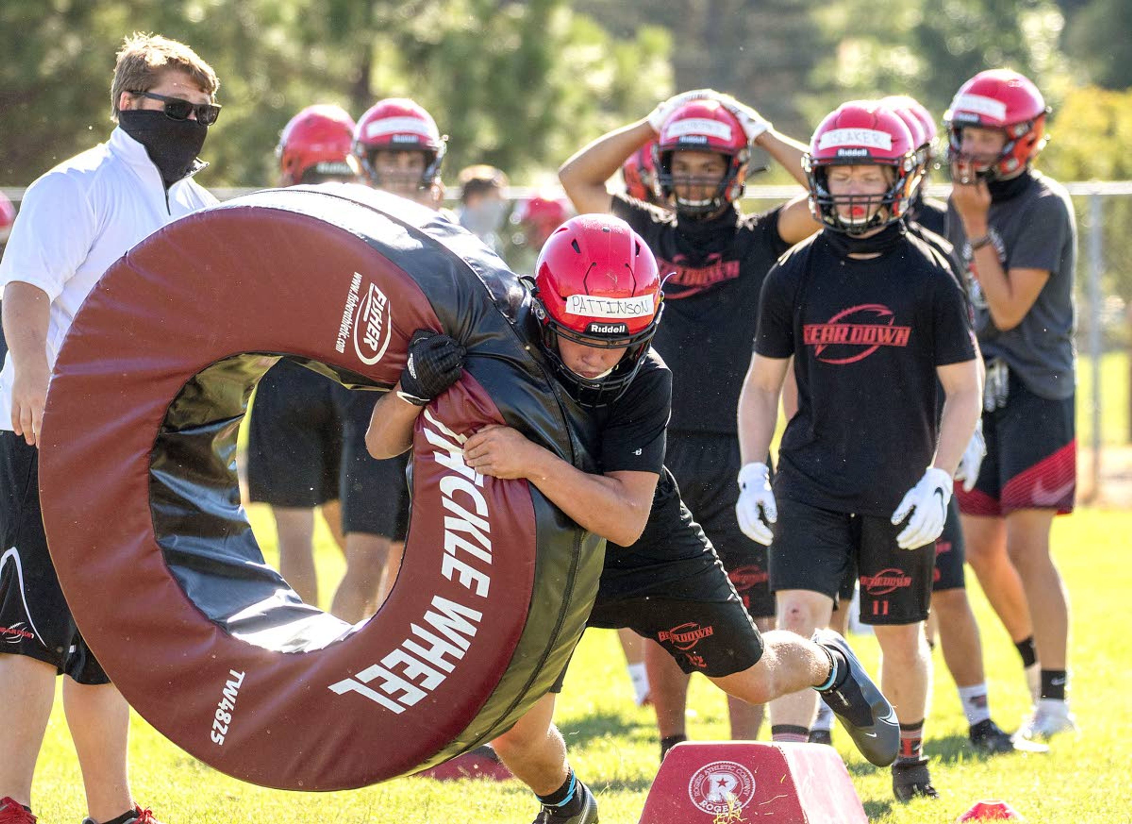 Moscow High School football players run a drill on Monday outside Moscow Middle School.