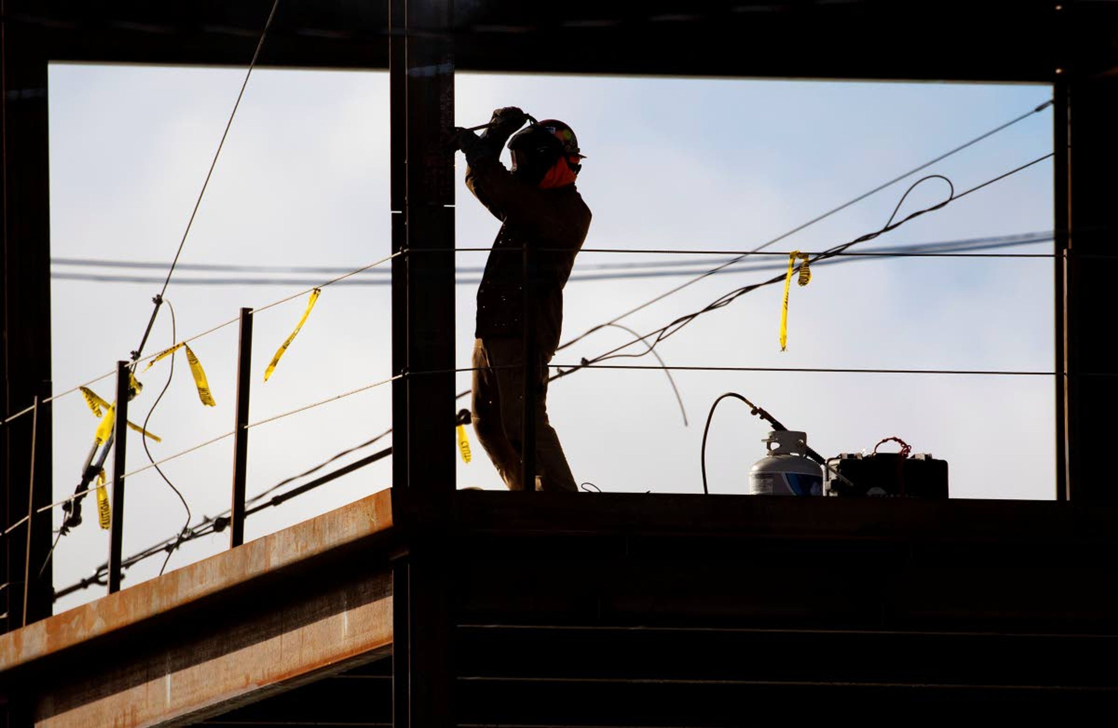 A welder works on the new Emsi building on Monday at the intersection of Jackson and C streets in Moscow.