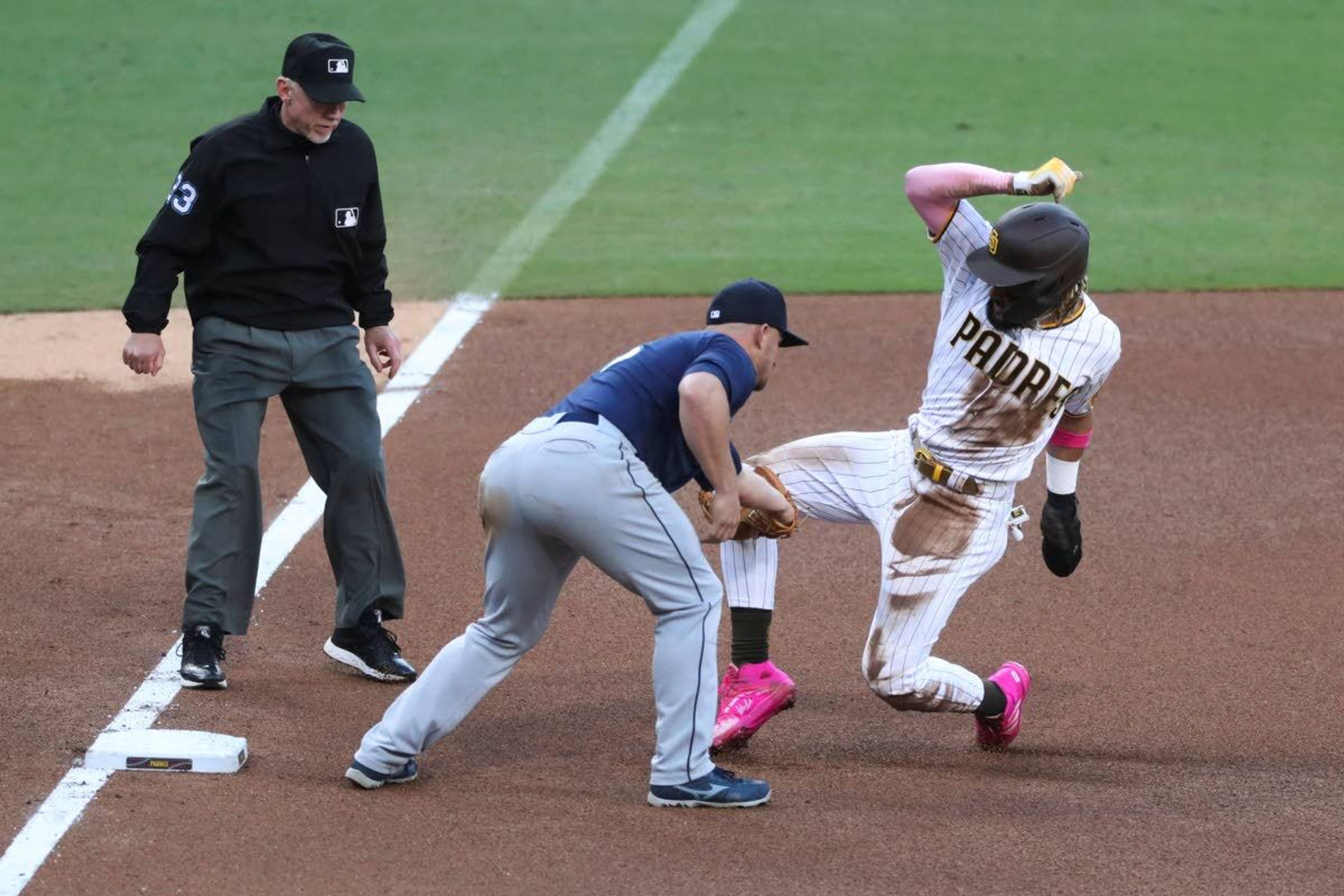 San Diego Padres' Fernando Tatis Jr. is tagged out by Seattle Mariners' Kyle Seager on an attempted steal of third during the fourth inning of a baseball game Saturday, May 22, 2021, in San Diego. (AP Photo/Derrick Tuskan)