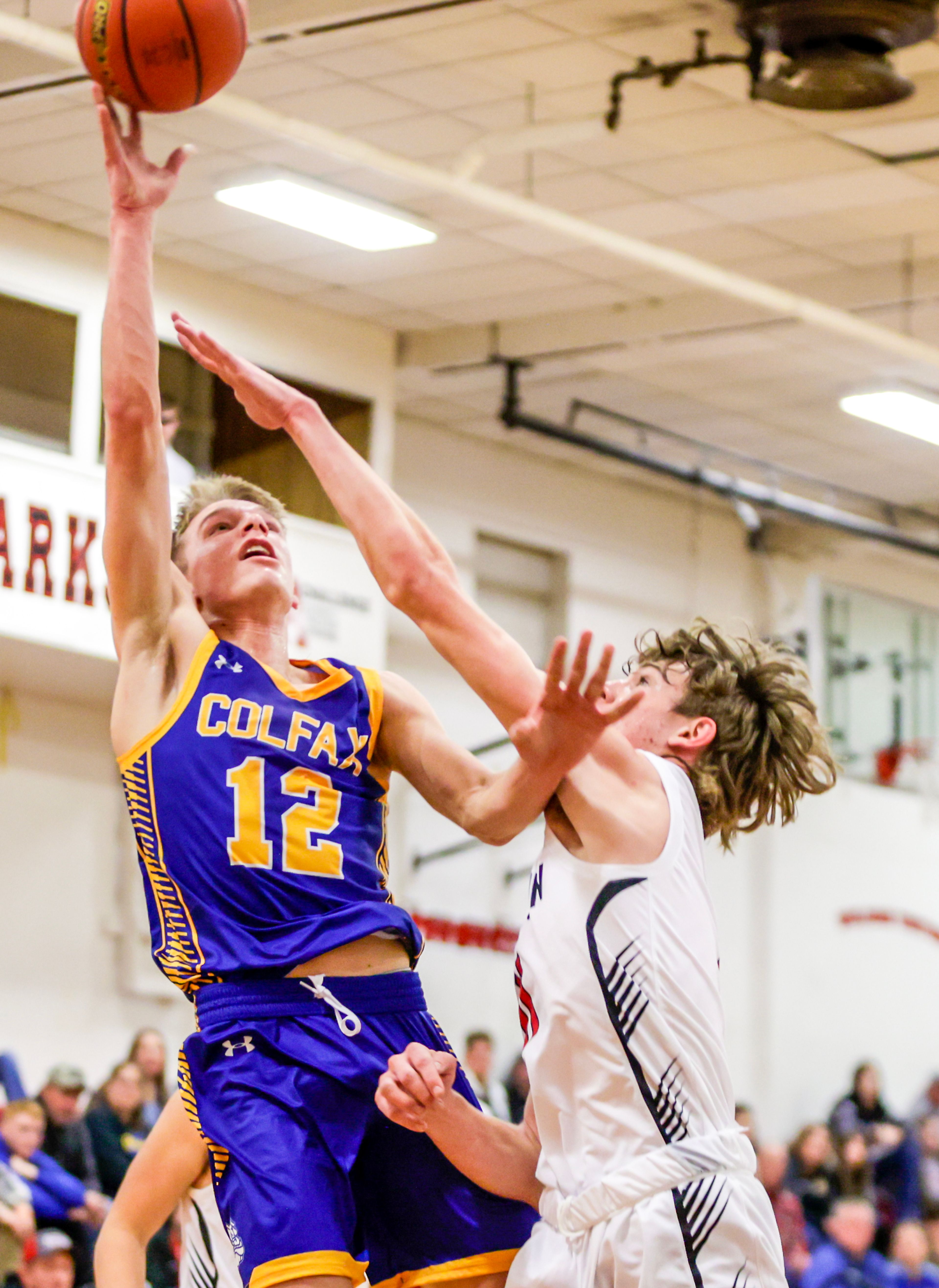 Colfax Seth Lustig shoots the ball as Clarkston forward Dustin Beck guards him in a quarter of a nonleague game Thursday at Clarkston.