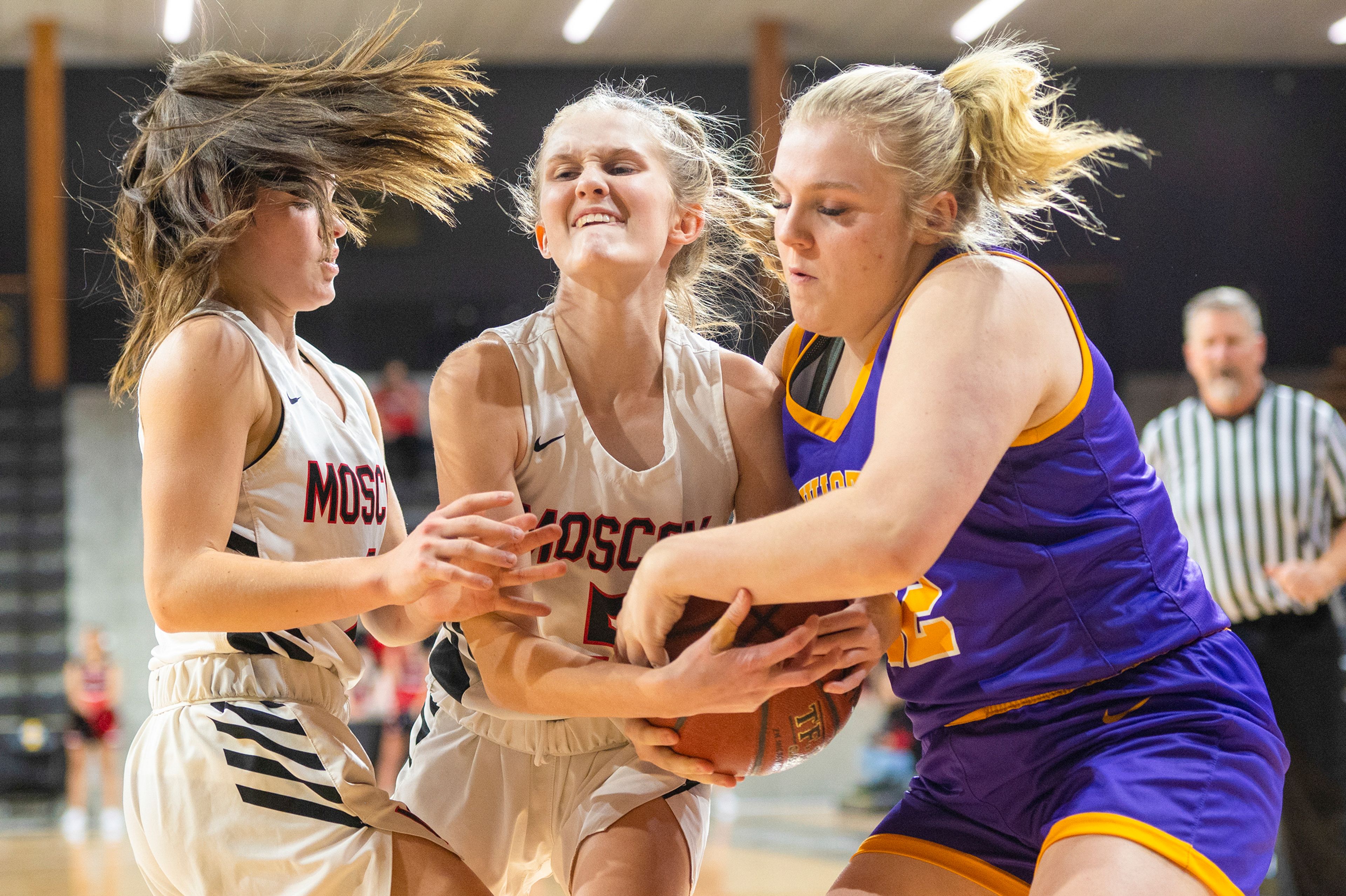 Moscow guard Kolbi Kiblen (5) fights for a loose ball against Lewiston guard Maddilynne Jackson (22) during a nonconference game at Idaho Central Credit Union Arena in Moscow on Monday.