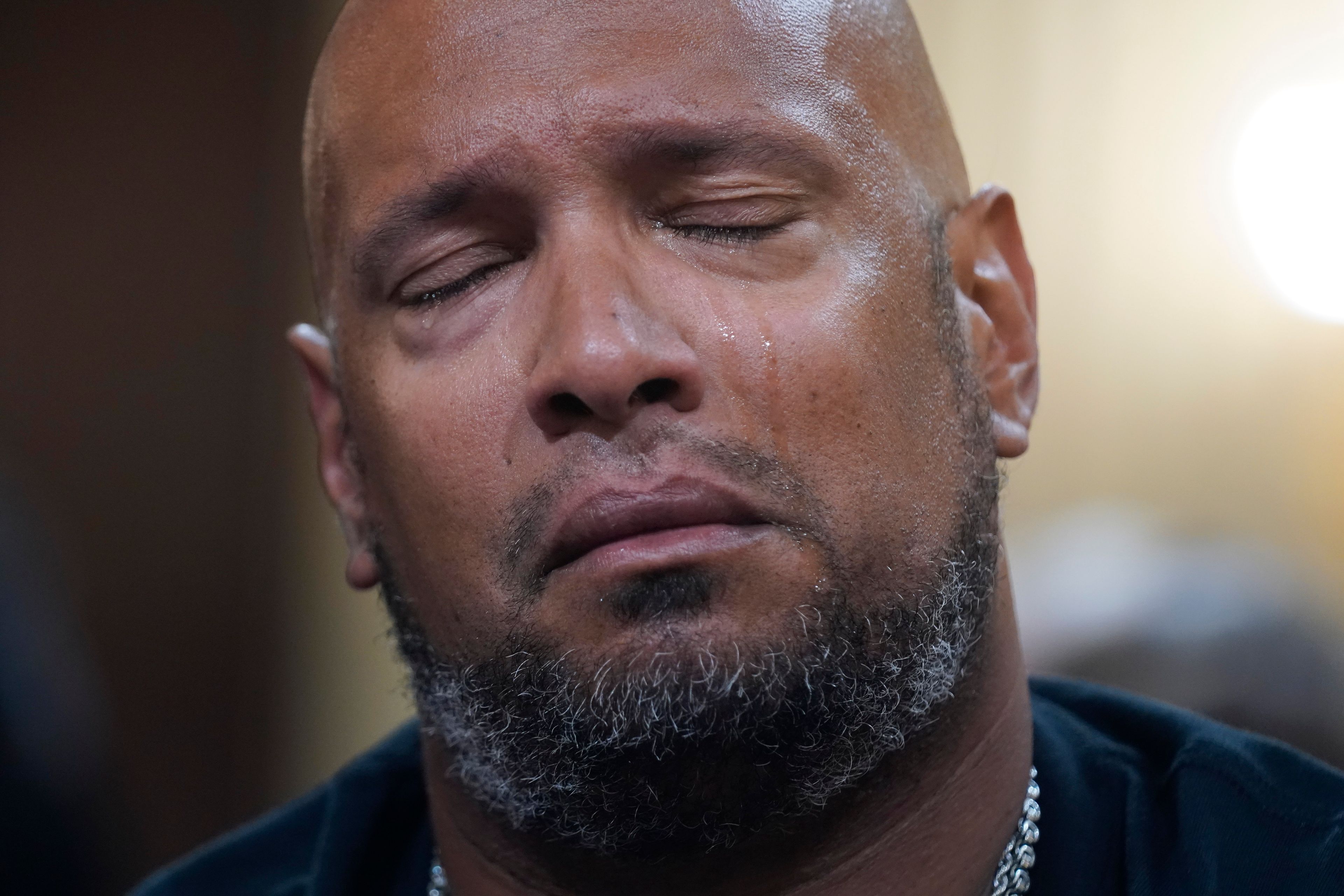 U.S. Capitol Police Sgt. Harry Dunn tears up as a video of the Jan. 6 attack on the U.S. Capitol is played during a public hearing of the House select committee investigating the attack is held on Capitol Hill, Thursday, June 9, 2022, in Washington. (AP Photo/Andrew Harnik)