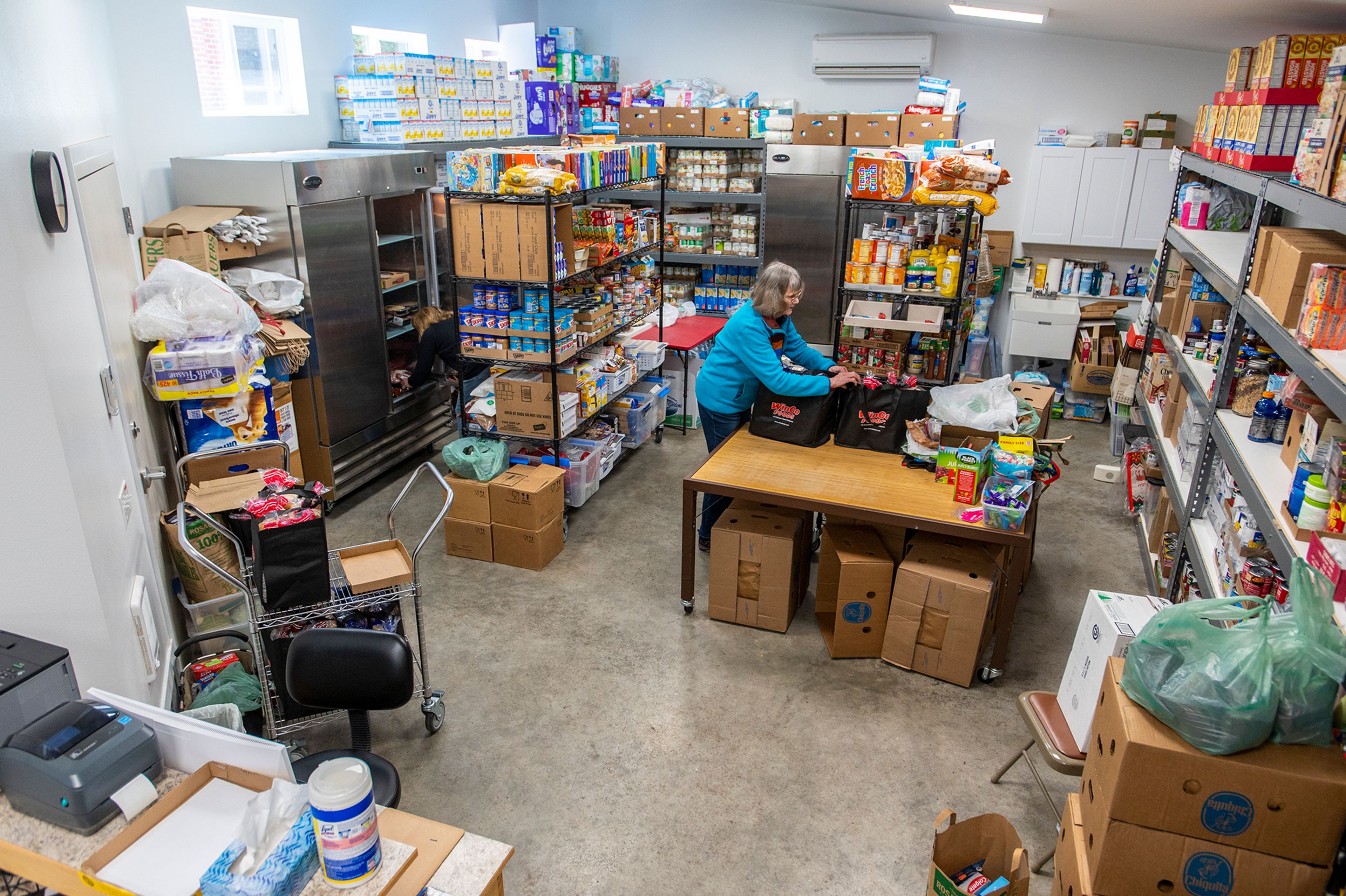 Volunteer Jerri Parce, left, and director Linda Nickels check inventory Thursday afternoon at the Moscow Food Bank.