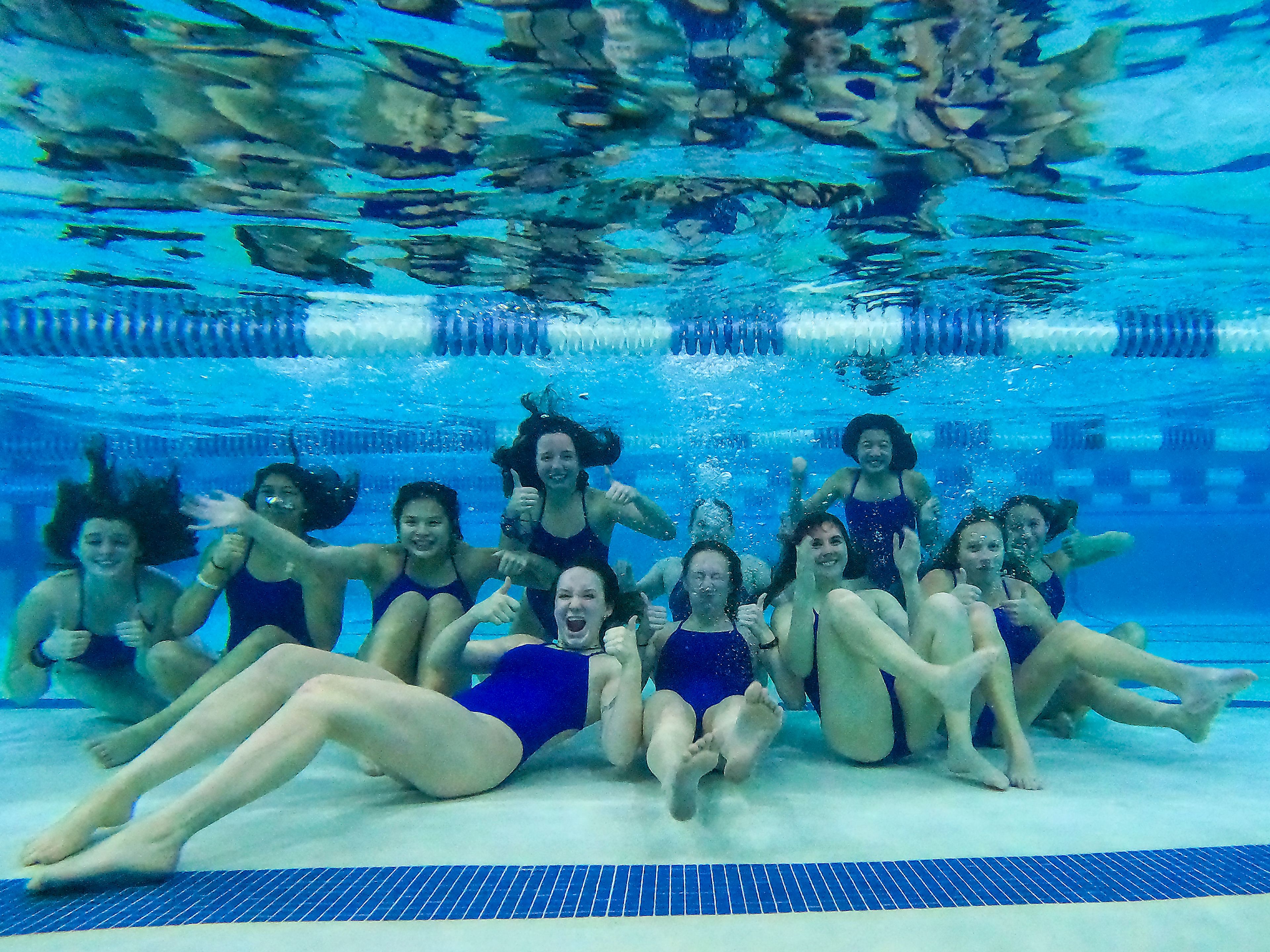 The Pullman High School girls swim team poses underwater following a practice Wednesday at the Pullman Aquatic Center in preparation for the Washington high school state swim meet.