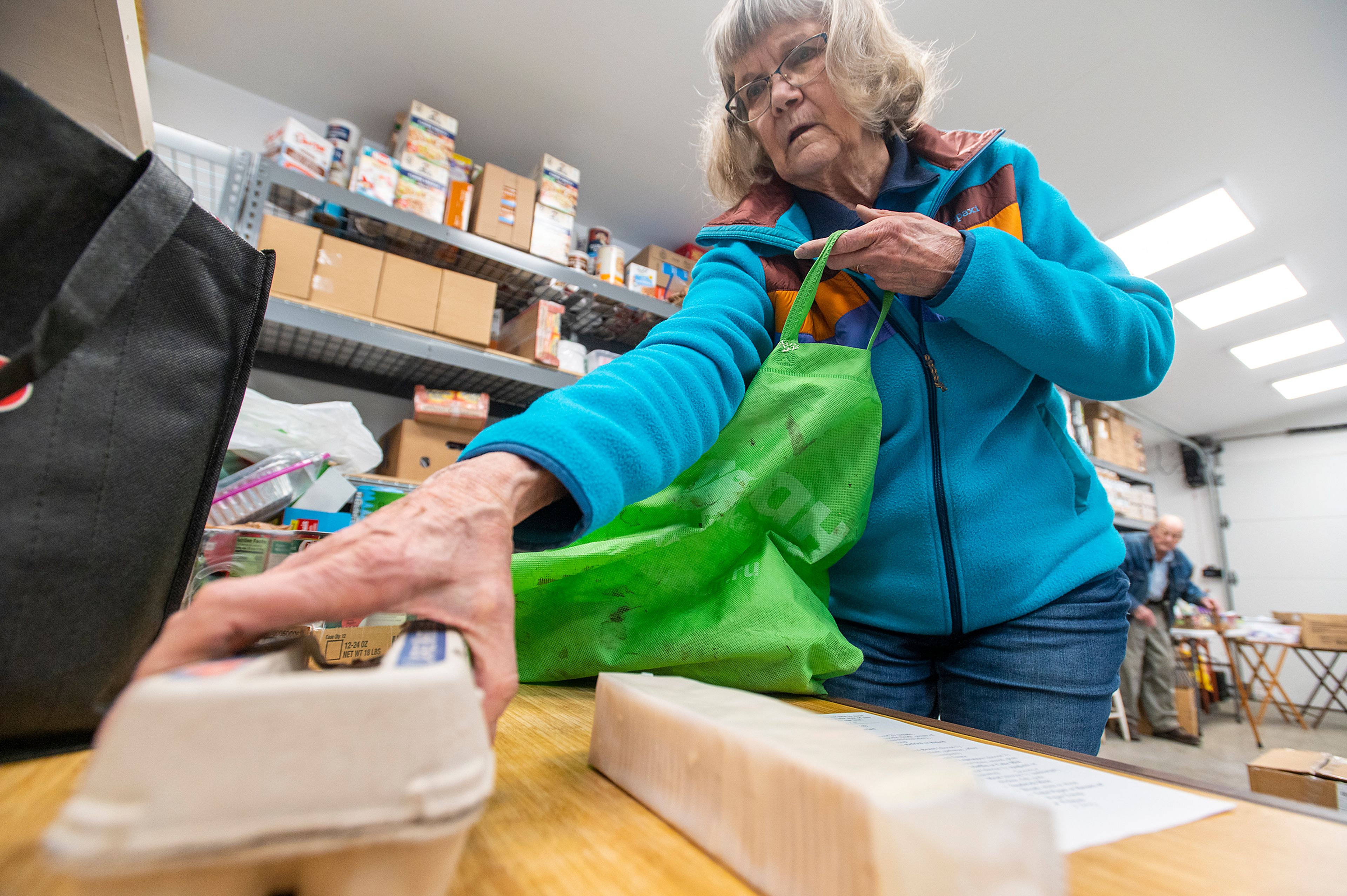 Zach Wilkinson/Daily News Moscow Food Bank director Linda Nickels packages an order Thursday for a man who asked to be identified as Allen.