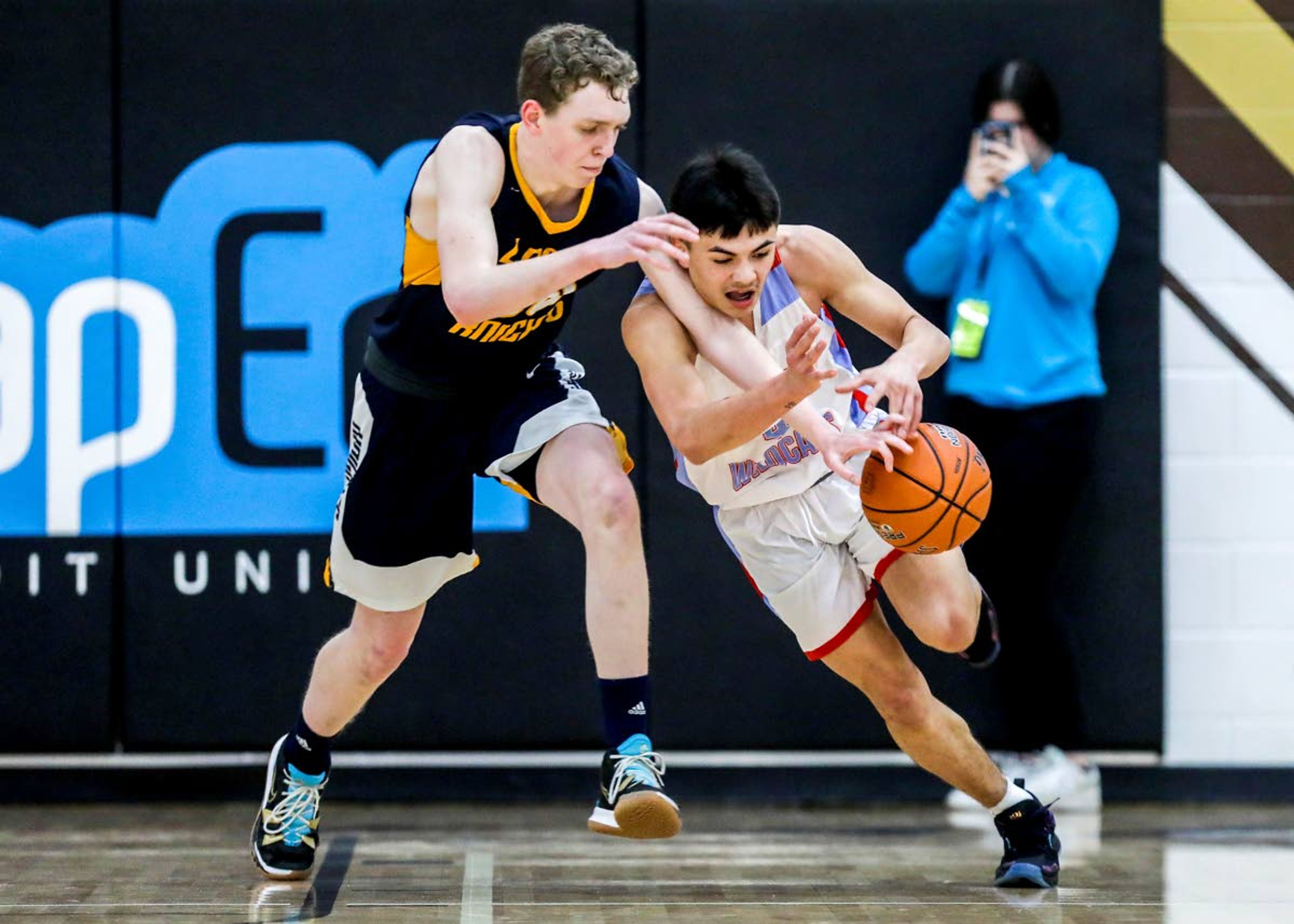 Logos Ben Druffel knocks the ball free of the hands of Lapwai guard Mason Brown during round two of the Idaho High School boys state basketball tournament at Vallivue High School on Friday.