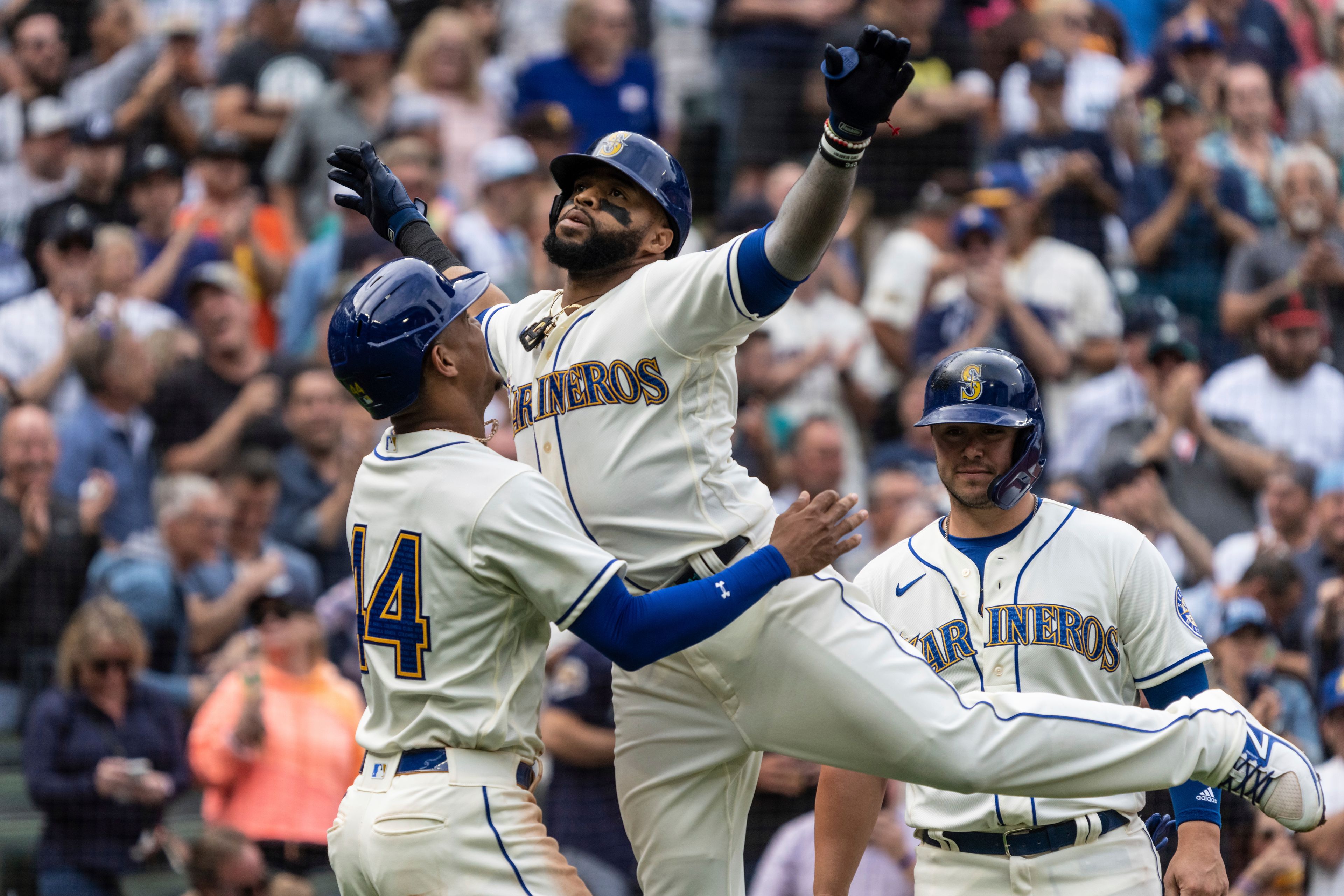 Seattle Mariners' Carlos Santana celebrates with Julio Rodriguez after hitting a three-run home run off San Diego Padres starting pitcher Mike Clevinger during the fifth inning of a baseball game, Wednesday, Sept. 14, 2022, in Seattle. (AP Photo/Stephen Brashear)