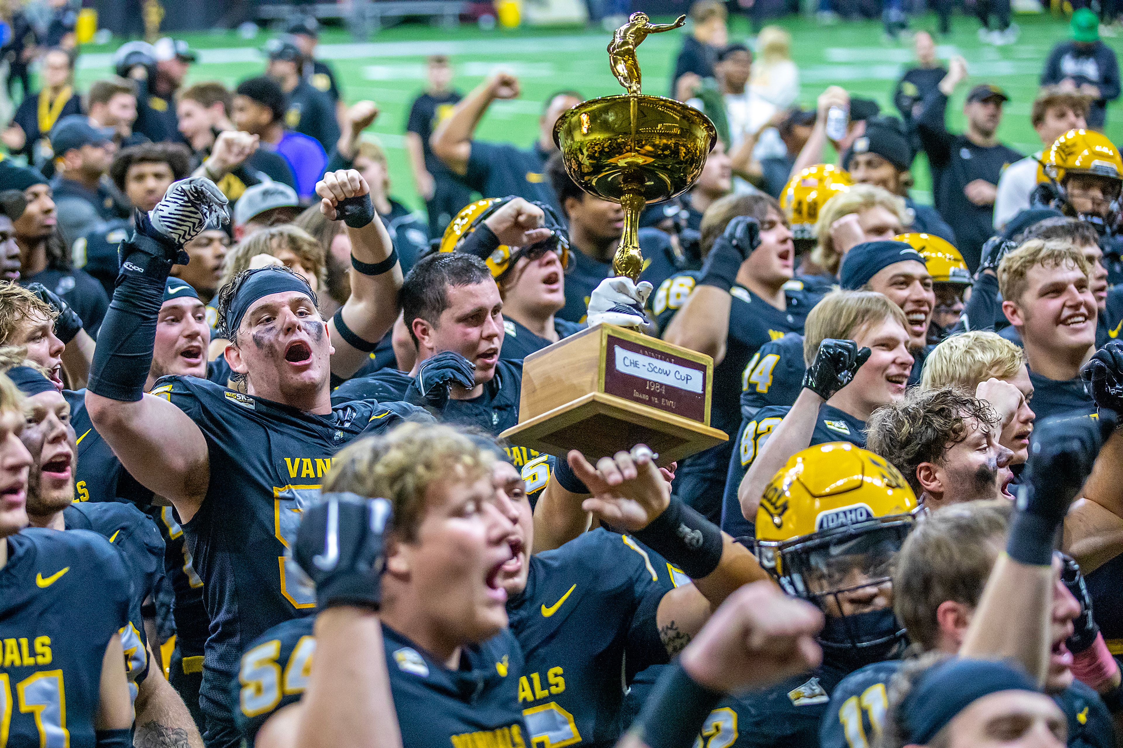 The Idaho Vandals sing their fight song as they hoist the "Che-Scow cup" trophy after defeating Eastern Washington 38-28 in a Big Sky game Saturday at the Kibbie Dome in Moscow.