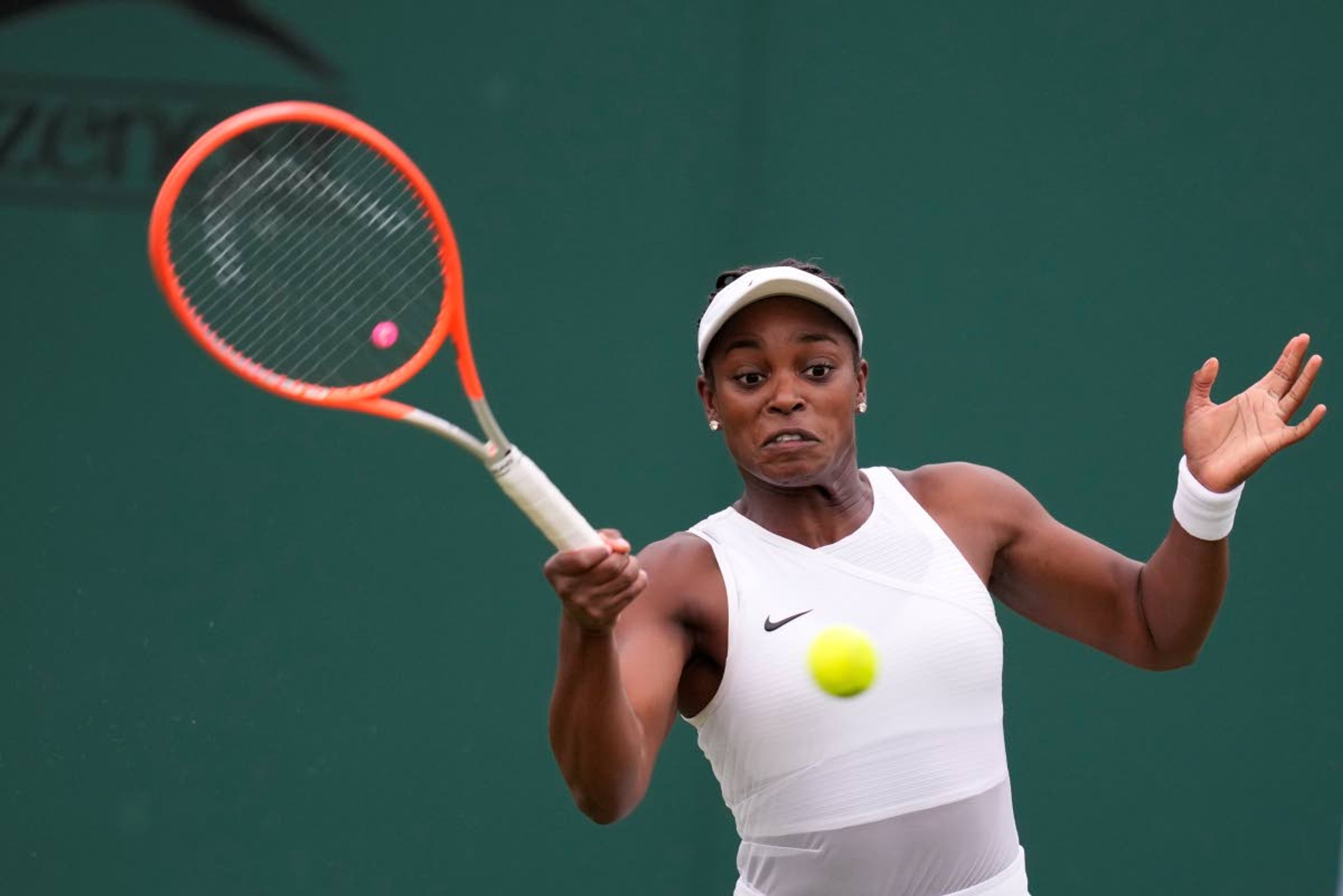 Sloane Stephens of the US plays a return to Kristie Ahn of the US during the women's singles second round match on day three of the Wimbledon Tennis Championships in London, Wednesday June 30, 2021. (AP Photo/Kirsty Wigglesworth)