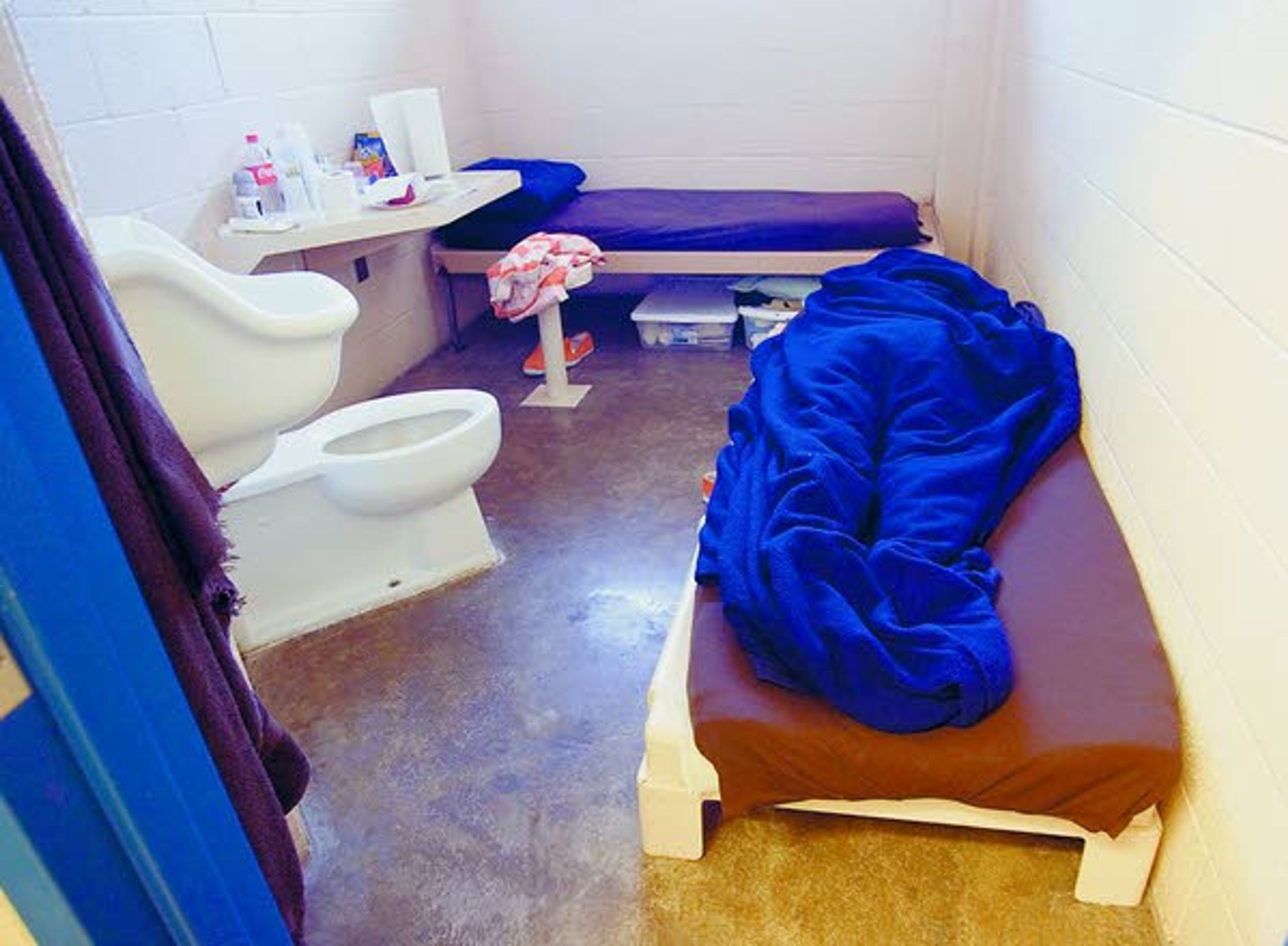 An inmate sleeps Tuesday on a temporary bed on the floor of a room at the Whitman County Jail in Colfax.