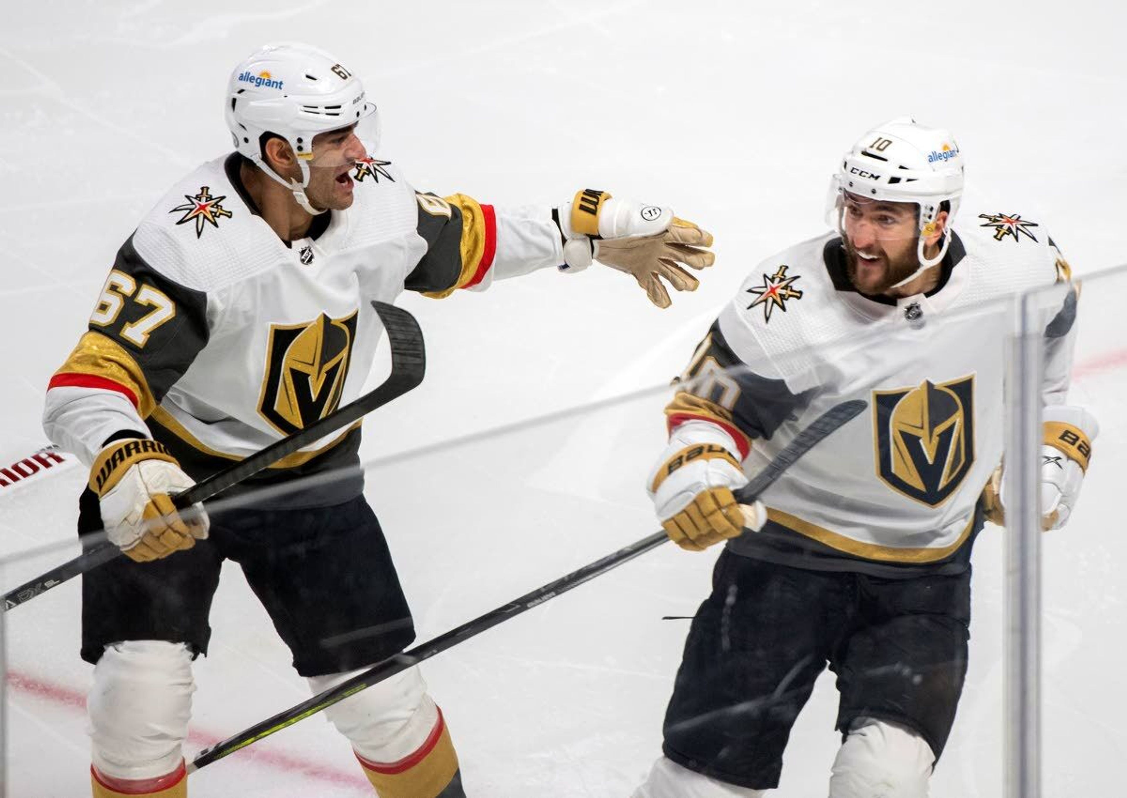 Vegas Golden Knights' Nicolas Roy (10) celebrates his game-winning goal against the Montreal Canadiens with teammate Max Pacioretty in overtime of Game 4 in an NHL Stanley Cup playoff hockey semifinal in Montreal, Sunday, June 20, 2021.