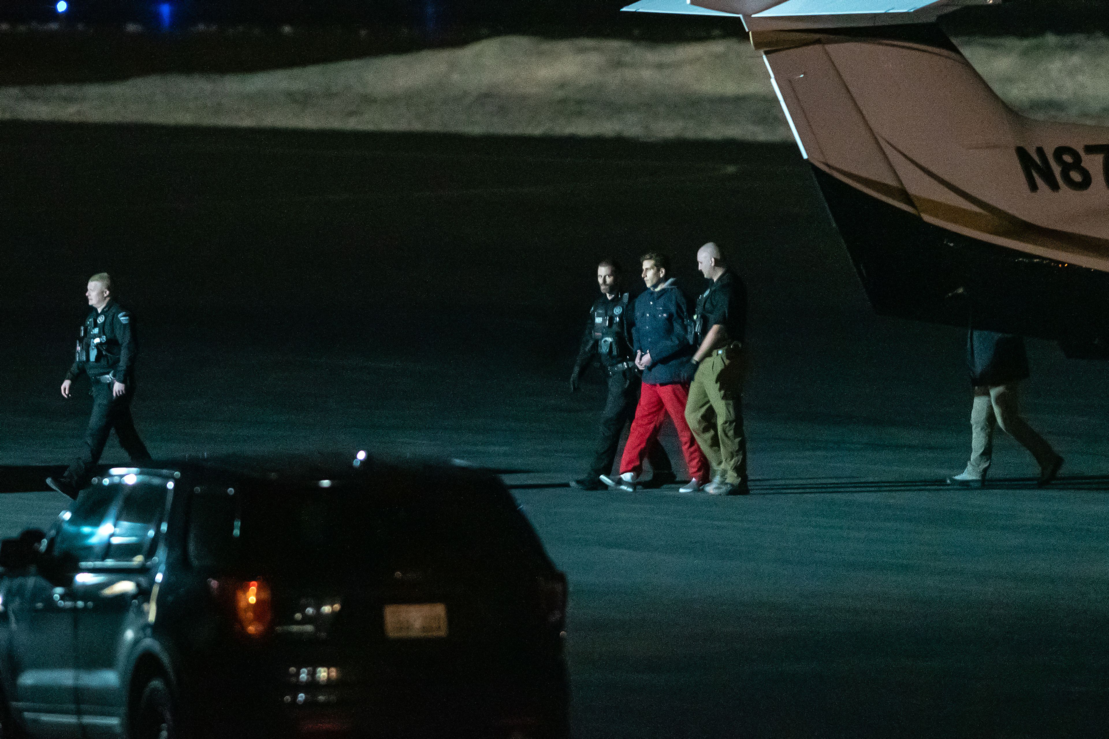 Bryan Kohberger is escorted by law enforcement after arriving at Pullman-Moscow Regional Airport on Wednesday evening.