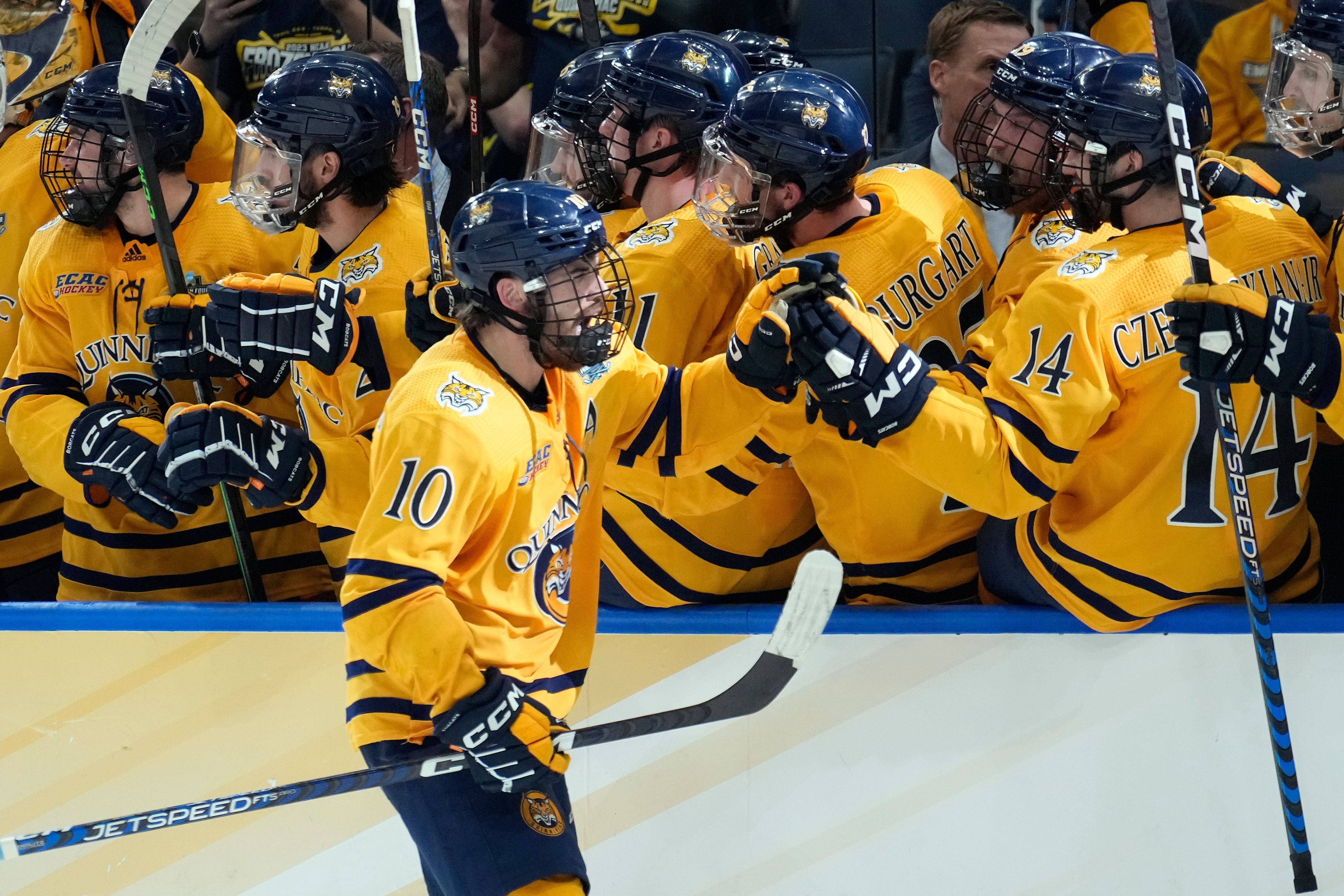 Quinnipiac forward Ethan de Jong (10) celebrates with the bench after his goal against Michigan during the third period of an NCAA semifinal game in the Frozen Four college hockey tournament Thursday, April 6, 2023, in Tampa, Fla. (AP Photo/Chris O'Meara)