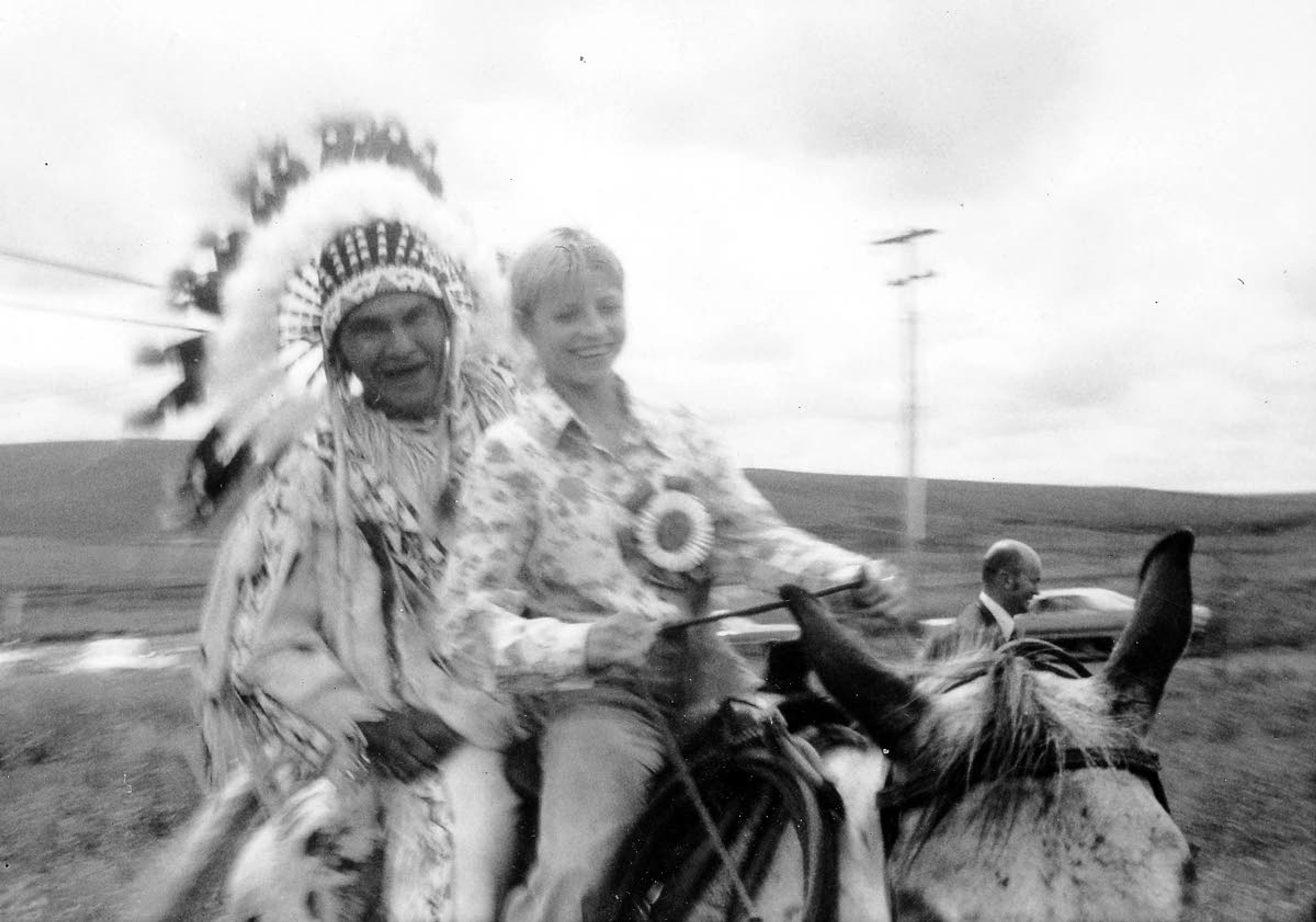 A member of the Nez Perce tribe rides along with an attendee at an Appaloosa Horse Club event in the 1960s.