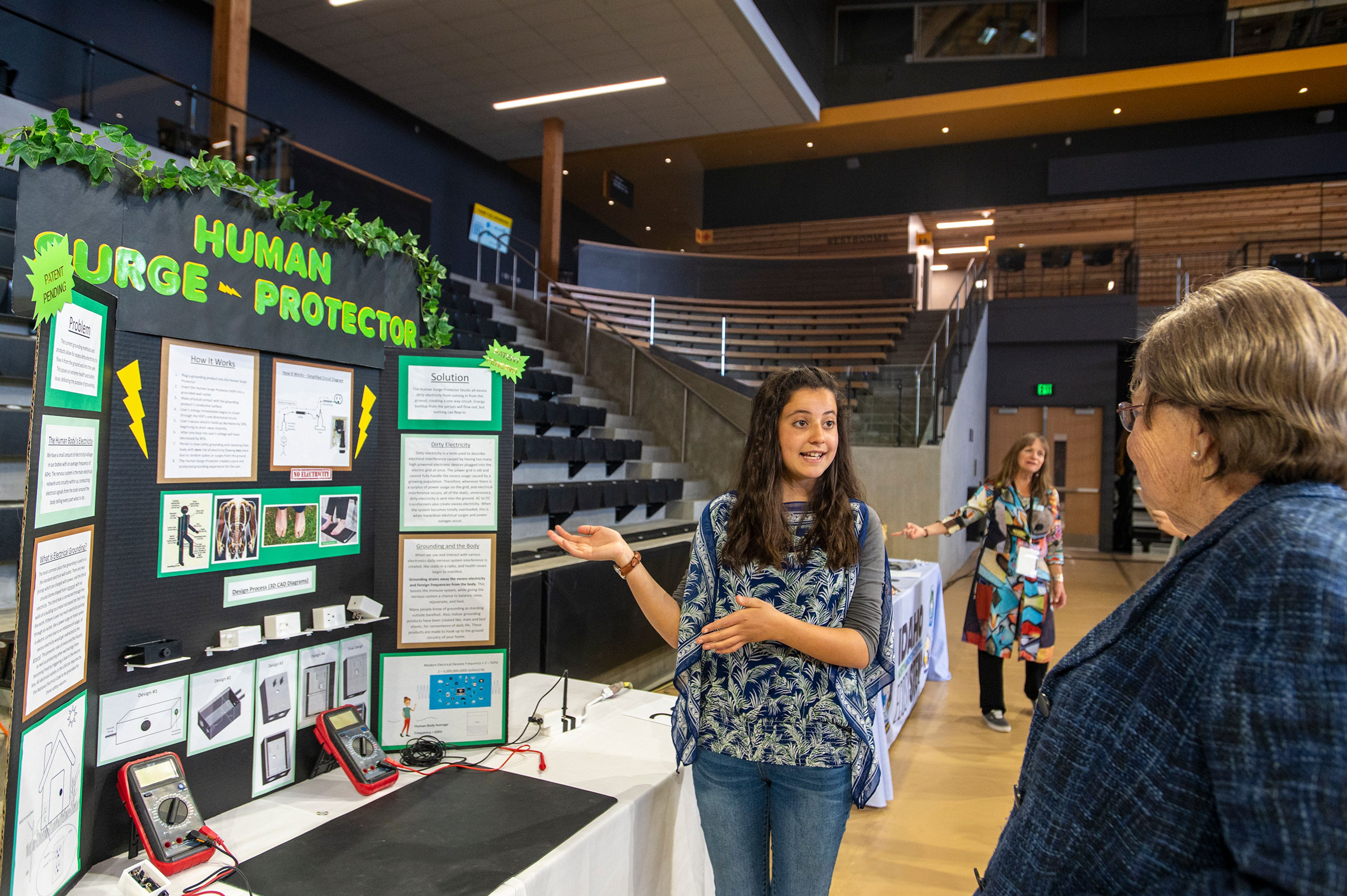 Arielle Levi, a 10th-grader from Caldwell, presents the Human Surge Protector during the University of Idaho College of Engineering’s annual Engineering Design Expo on Friday in the Idaho Central Credit Union Arena in Moscow.