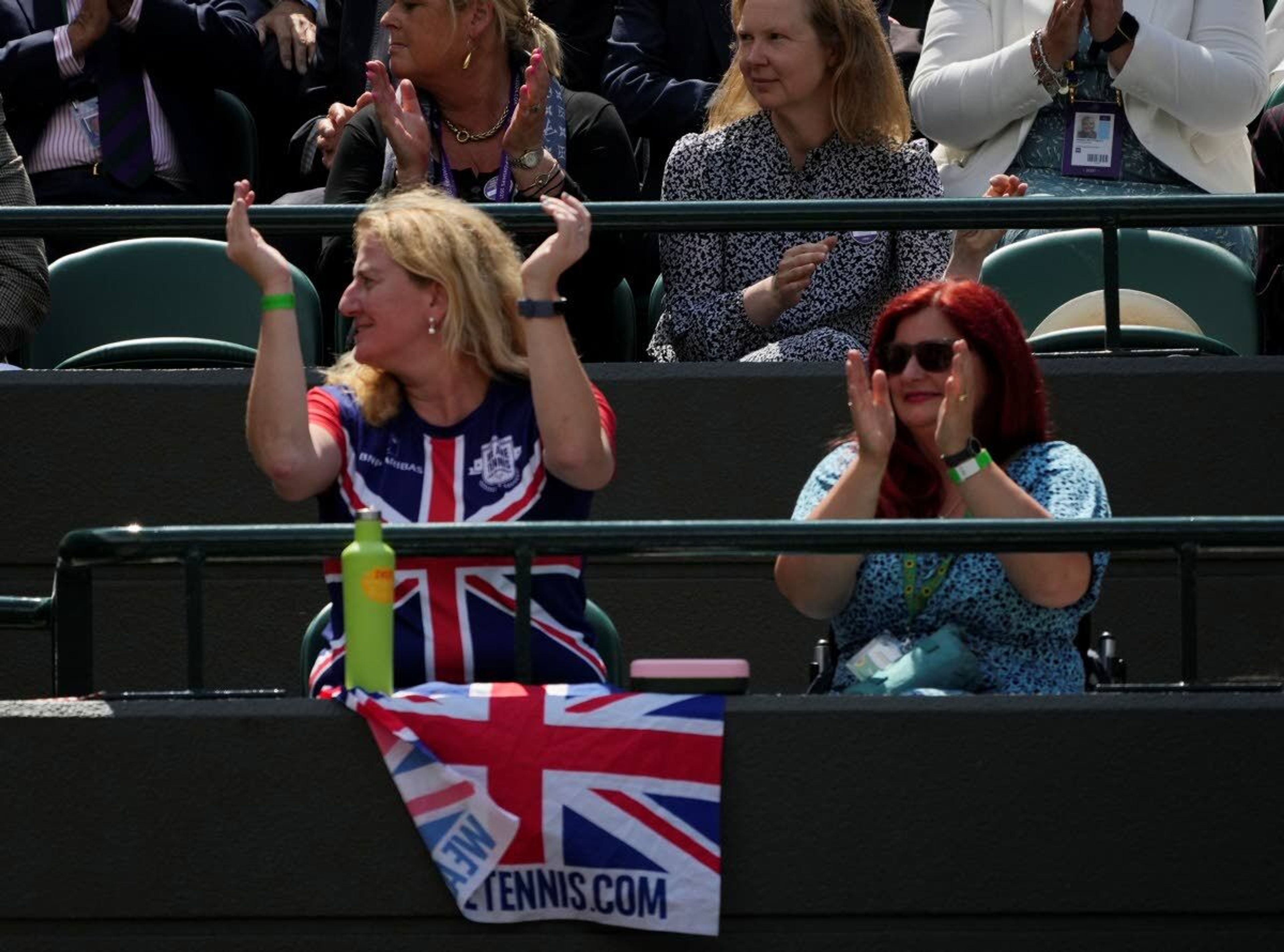 Tennis fans watch the women's singles third round match between Britain's Emma Raducanu and Romania's Sorana Cirstea on day six of the Wimbledon Tennis Championships in London, Saturday July 3, 2021. (AP Photo/Alberto Pezzali)