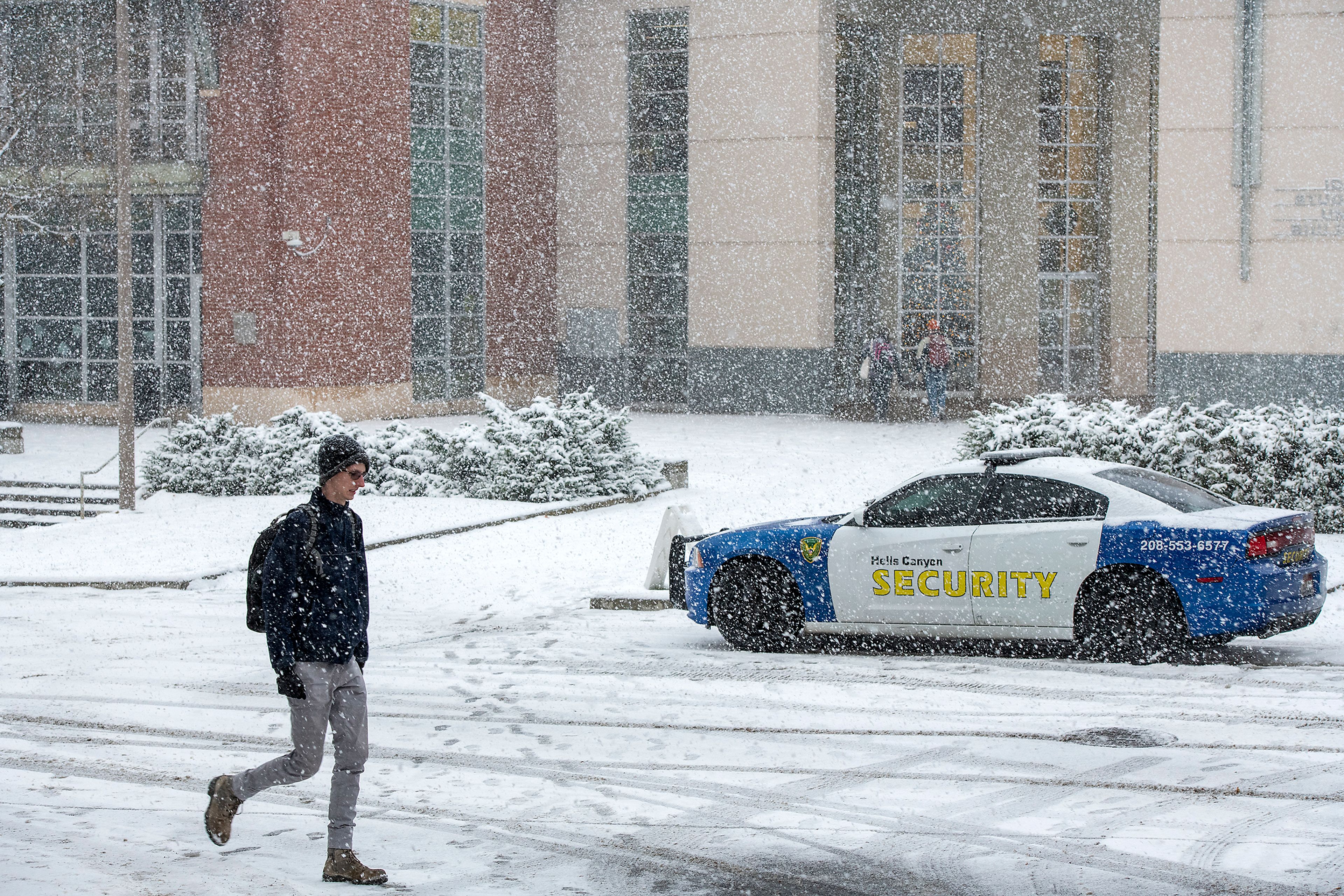 A Hells Canyon Security vehicle parks outside of the Idaho Student Union Building on University of Idaho’s campus in Moscow as the quadruple homicide investigation involving four students continues.