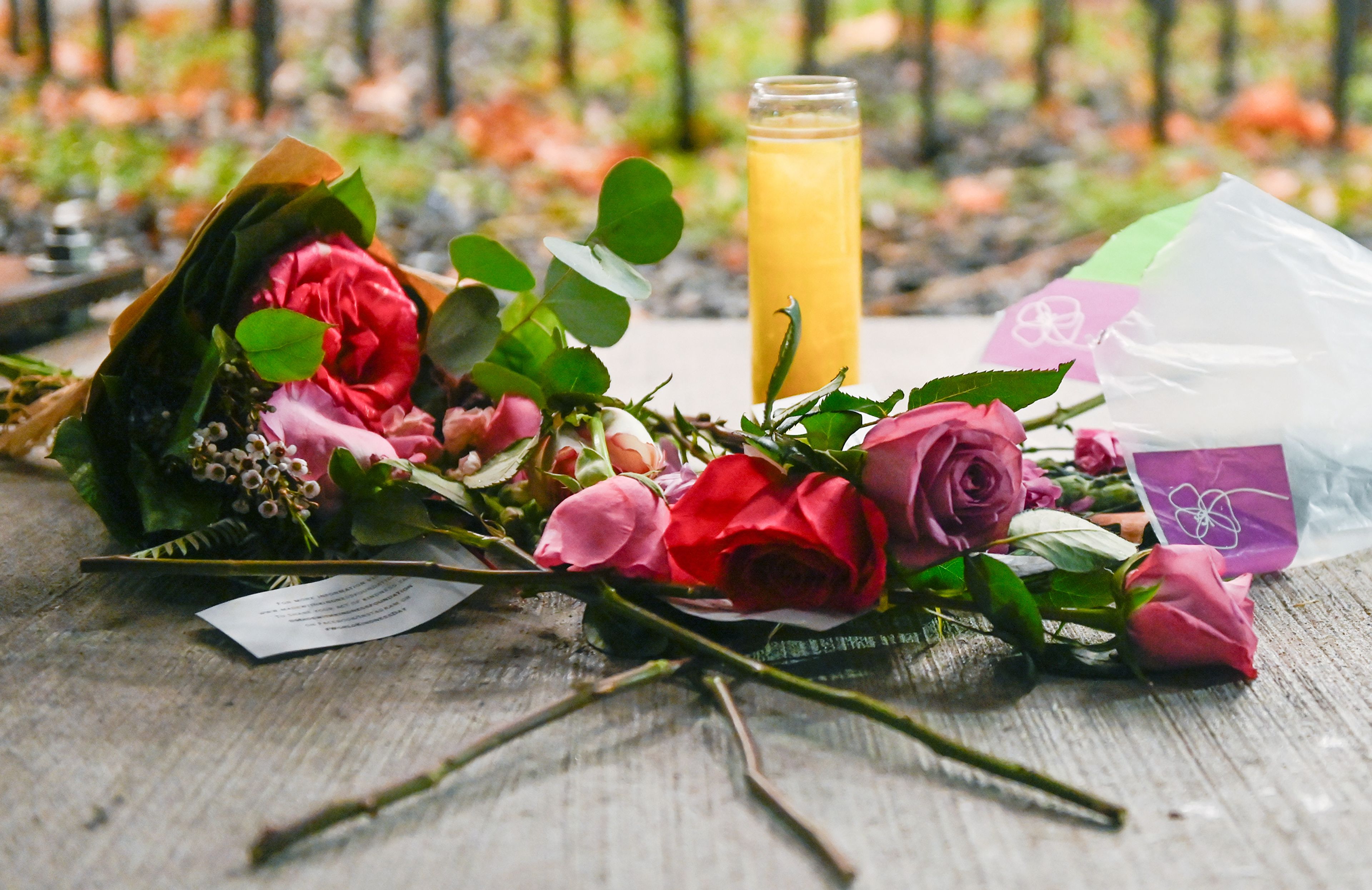 Flowers are left Wednesday below plaques of the names of Xana Kernodle, Madison Mogen, Kaylee Goncalves and Ethan Chapin at the Vandal Healing Garden and Memorial at vigil two years after their murders in Moscow.