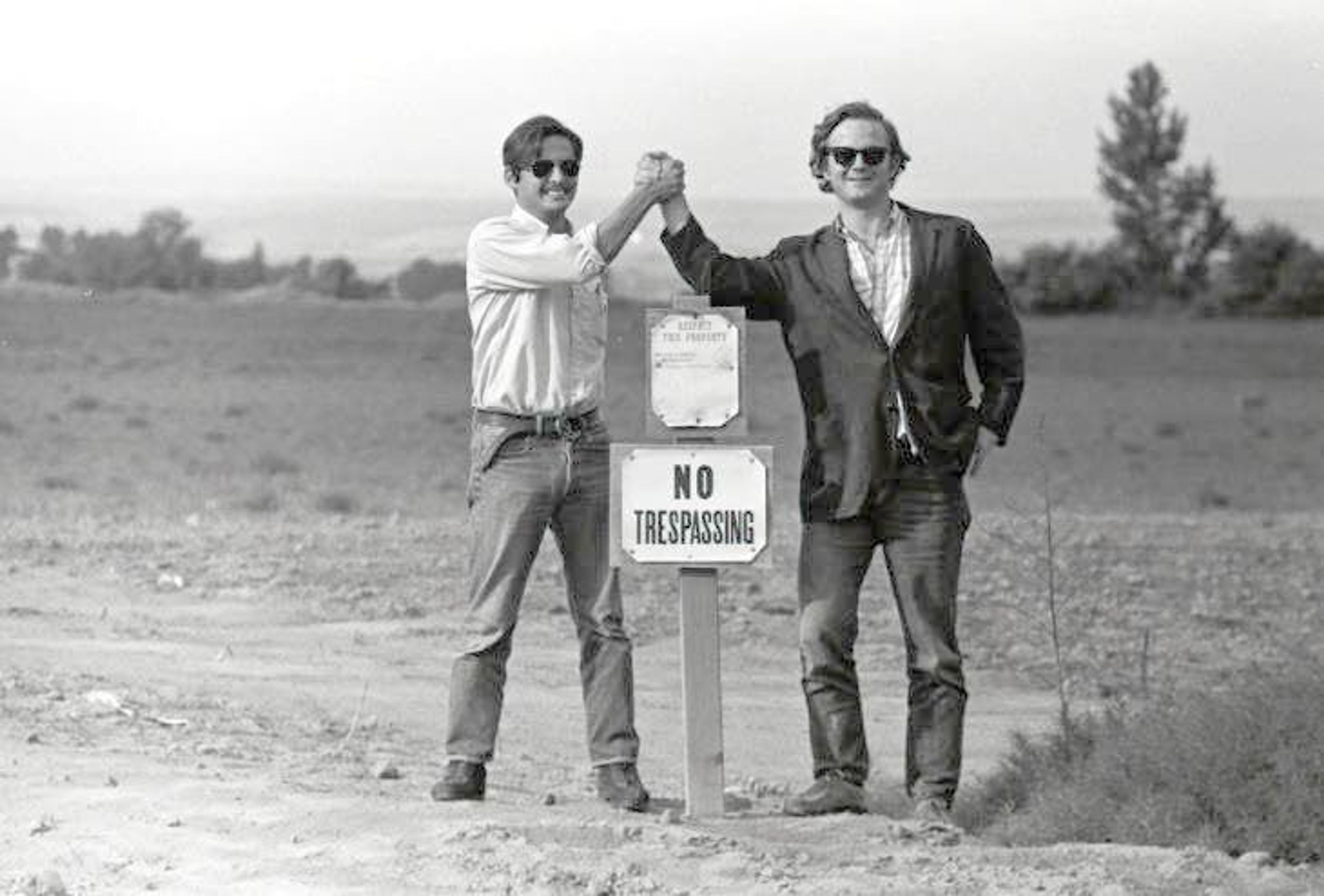 Guadalupe Gamboa and Michael Fox clasp hands above a “No Trespassing” sign in in 1971. The photo was taken at a Walla Walla labor camp.