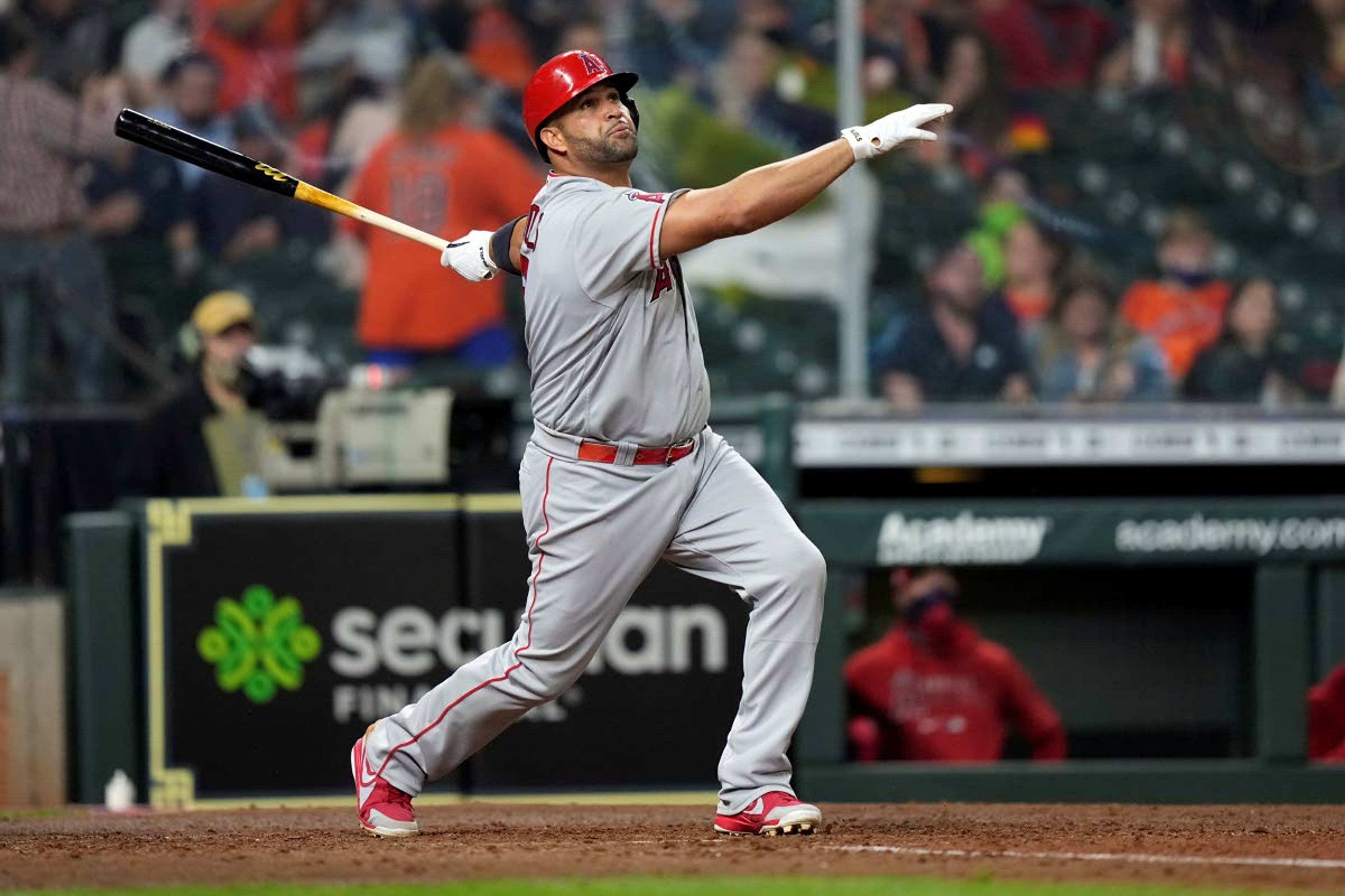 FILE - Los Angeles Angels' Albert Pujols hits a two-run home run against the Houston Astros during the sixth inning of a baseball game in Houston, in this Thursday, April 22, 2021, file photo. Pujols has been designated for assignment by the Los Angeles Angels, abruptly ending the 41-year-old superstar slugger's decade with his second major league team. The Angels announced the move Thursday, May 6, 2021, a day after Pujols wasn't in their lineup for their fourth consecutive loss. (AP Photo/David J. Phillip, File)