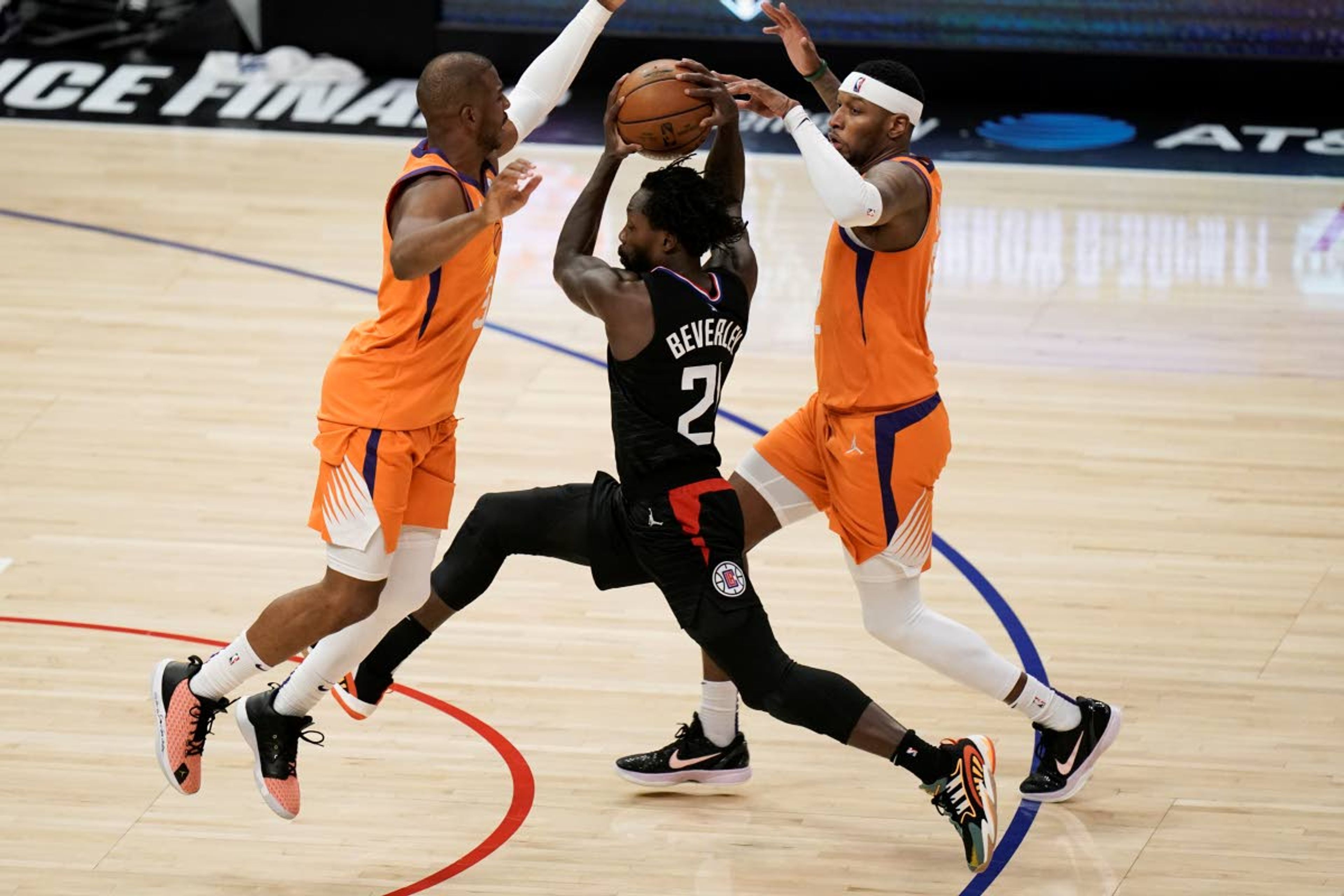 Los Angeles Clippers' Patrick Beverley, center, is double-teamed by Phoenix Suns' Chris Paul, left, and Torrey Craig during the second half in Game 6 of the NBA basketball Western Conference Finals Wednesday, June 30, 2021, in Los Angeles. (AP Photo/Jae C. Hong)