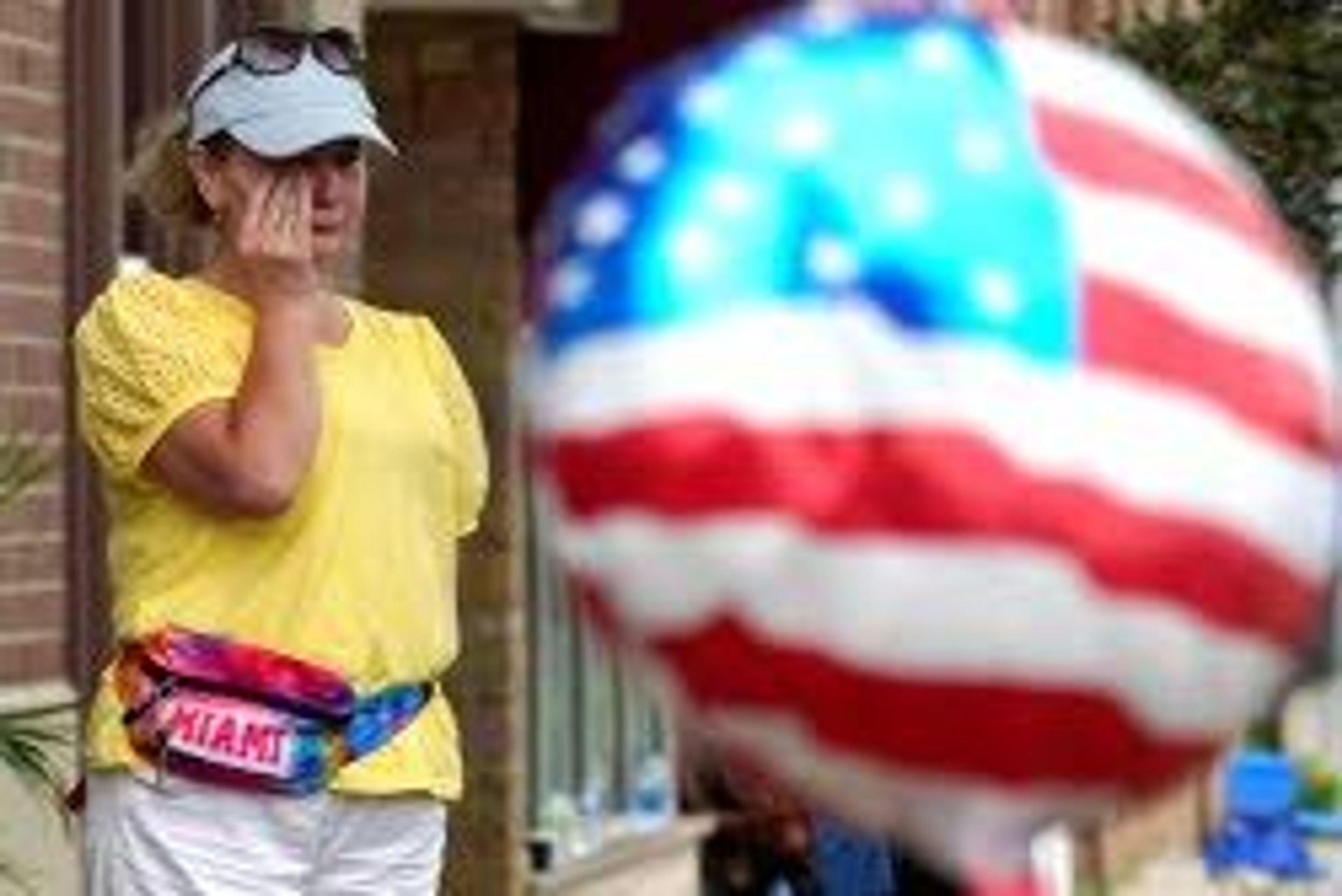 A woman wipes tears after a mass shooting at the Highland Park Fourth of July parade in Highland Park, Ill., a Chicago suburb, Monday, July 4, 2022. (AP Photo/Nam Y. Huh)