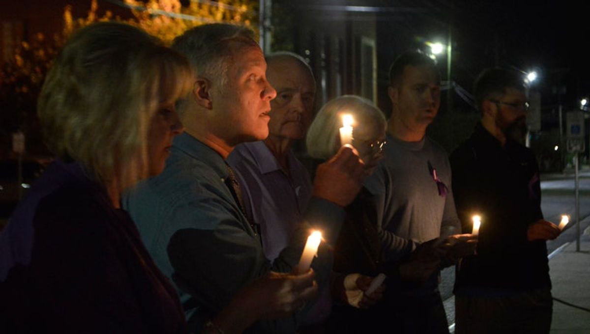 Vigil shines light on domestic violence