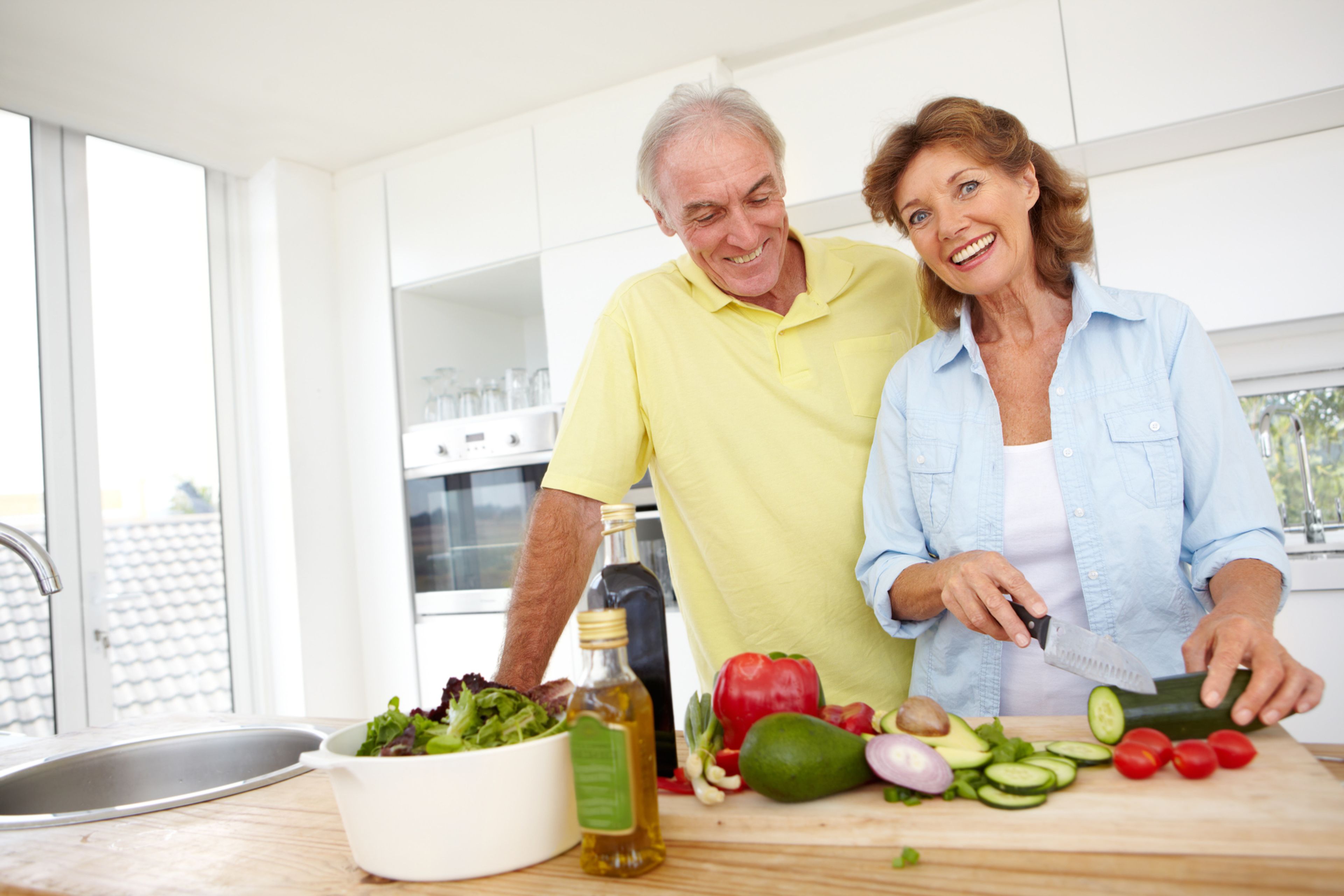 Portrait of a happy elderly couple making a healthy meal together in their kitchen