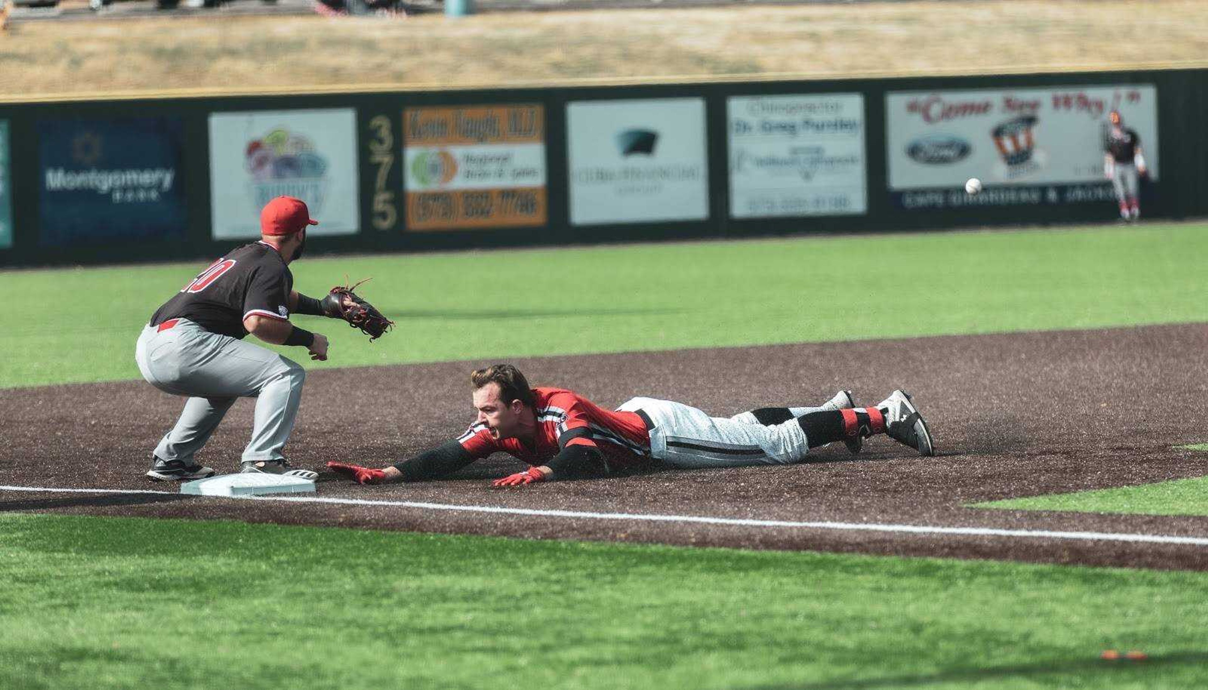Senior Tyler Wilber slides into third base after his big hit in game 1 of the Redhawks double-header on Saturday, Feb. 22.