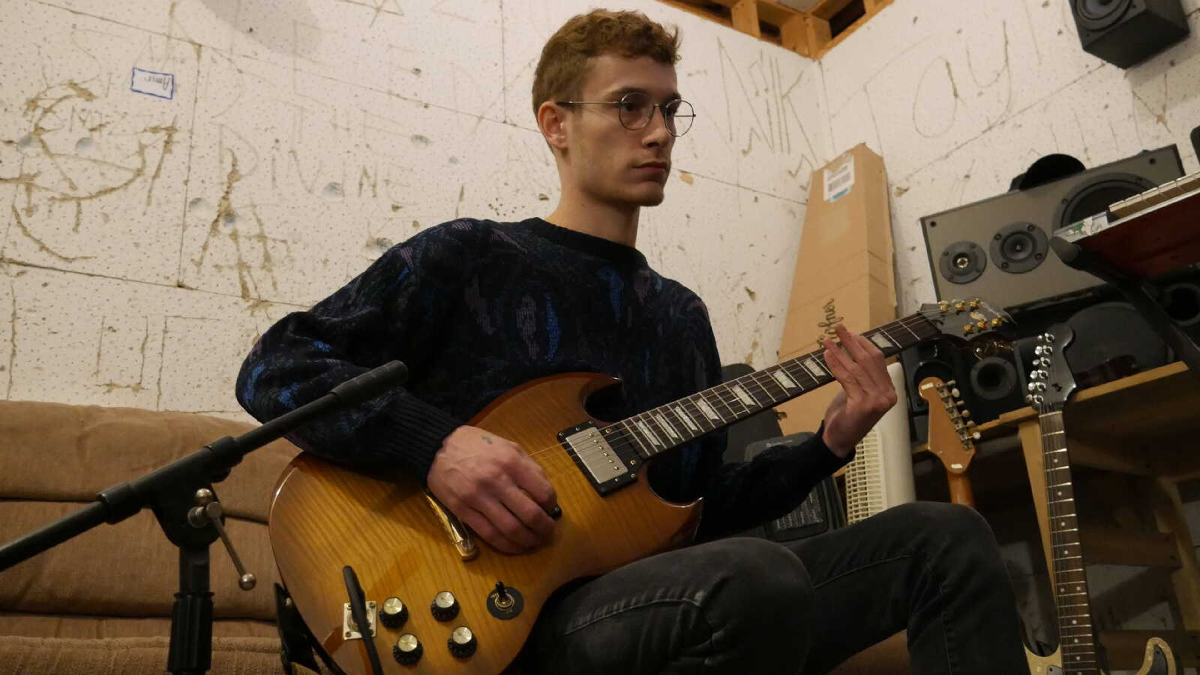 23-year-old Southeast freshman Nik Scarpaci, founder, vocalist, and composer for Noir Daze records a guitar part at his home studio in Jackson, Missouri.