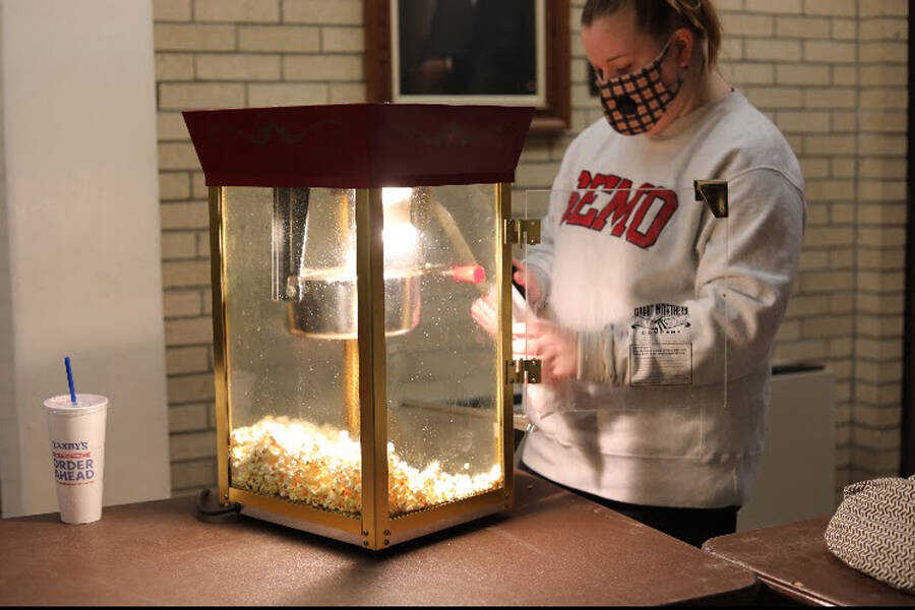 Anna Ockel, Student Activities Counsel president, pops popcorn before the movie “The King of Staten Island” starts on Sat., Jan 30, at Grauel. Inside Rose Theater, the movie starts by showing Pete Davidson’s character, Scott Carlin, driving down the road with his eyes closed.