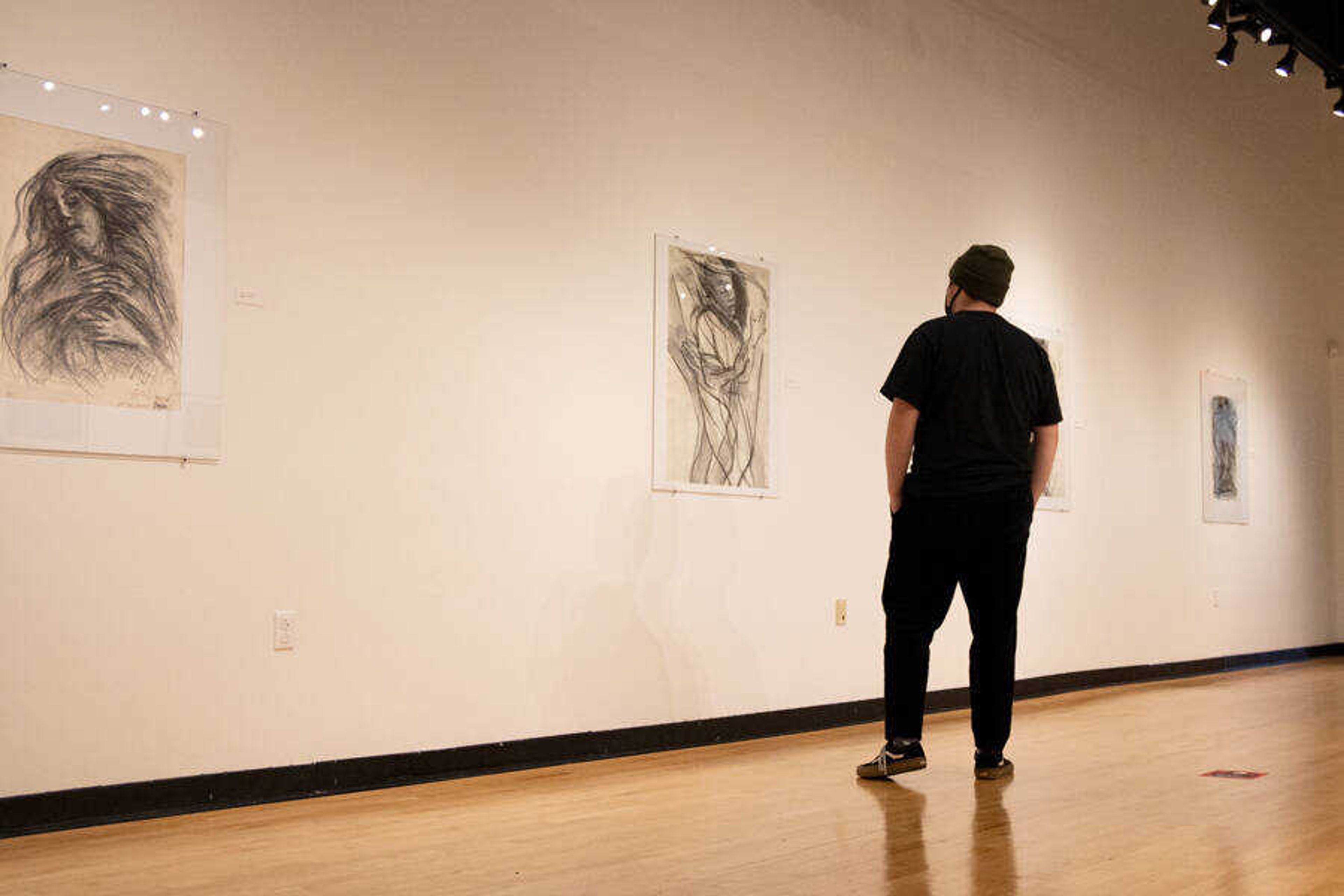Senior, John Stringer walks through the "Art From The Heart" gallery at Crisp Museum. October 8, 2020.
