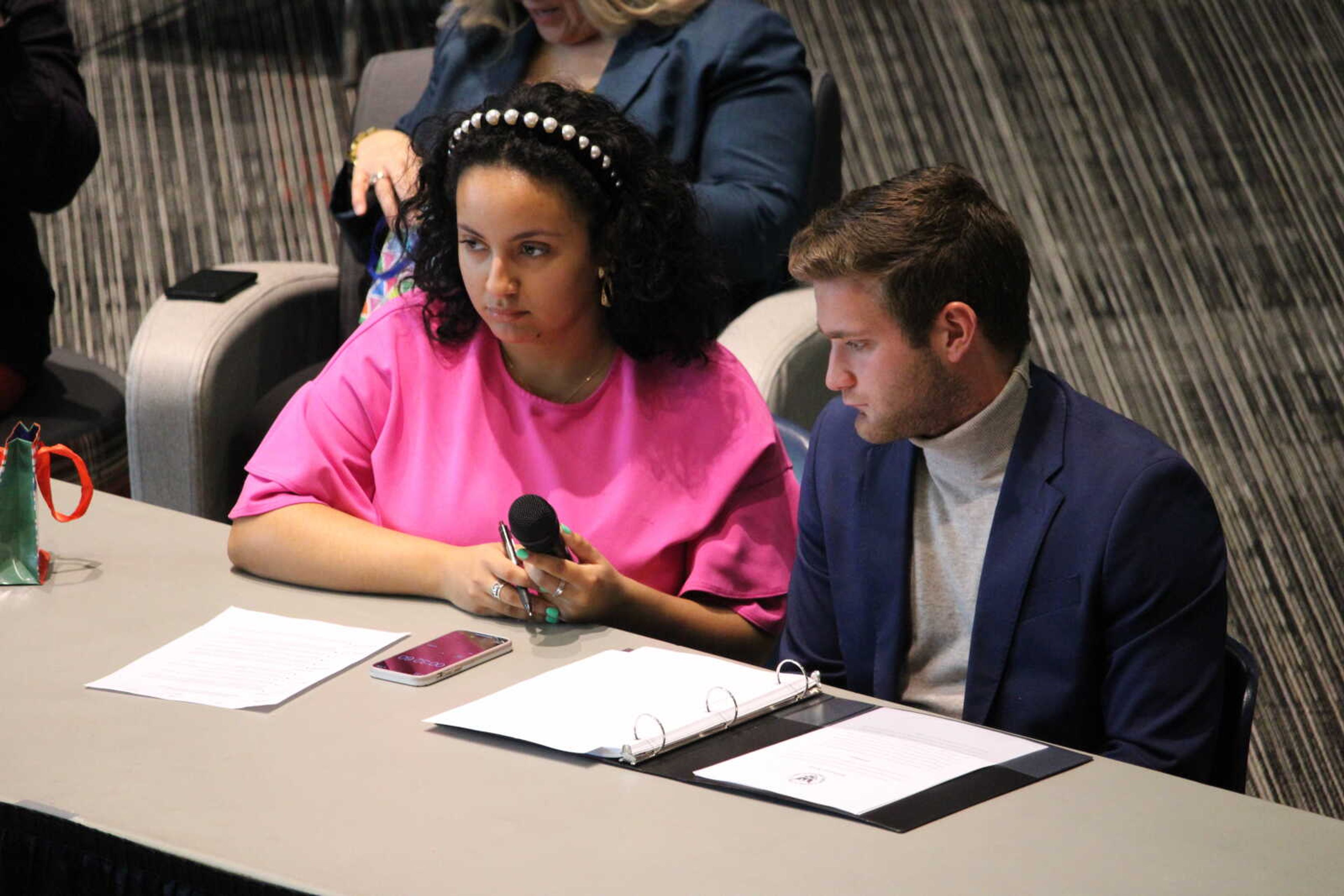 Current SGA president Layla Bouzihay [left] and vice president Nolan Knupp ask the 2022-23 SGA candidates questions at the debate on March 30.