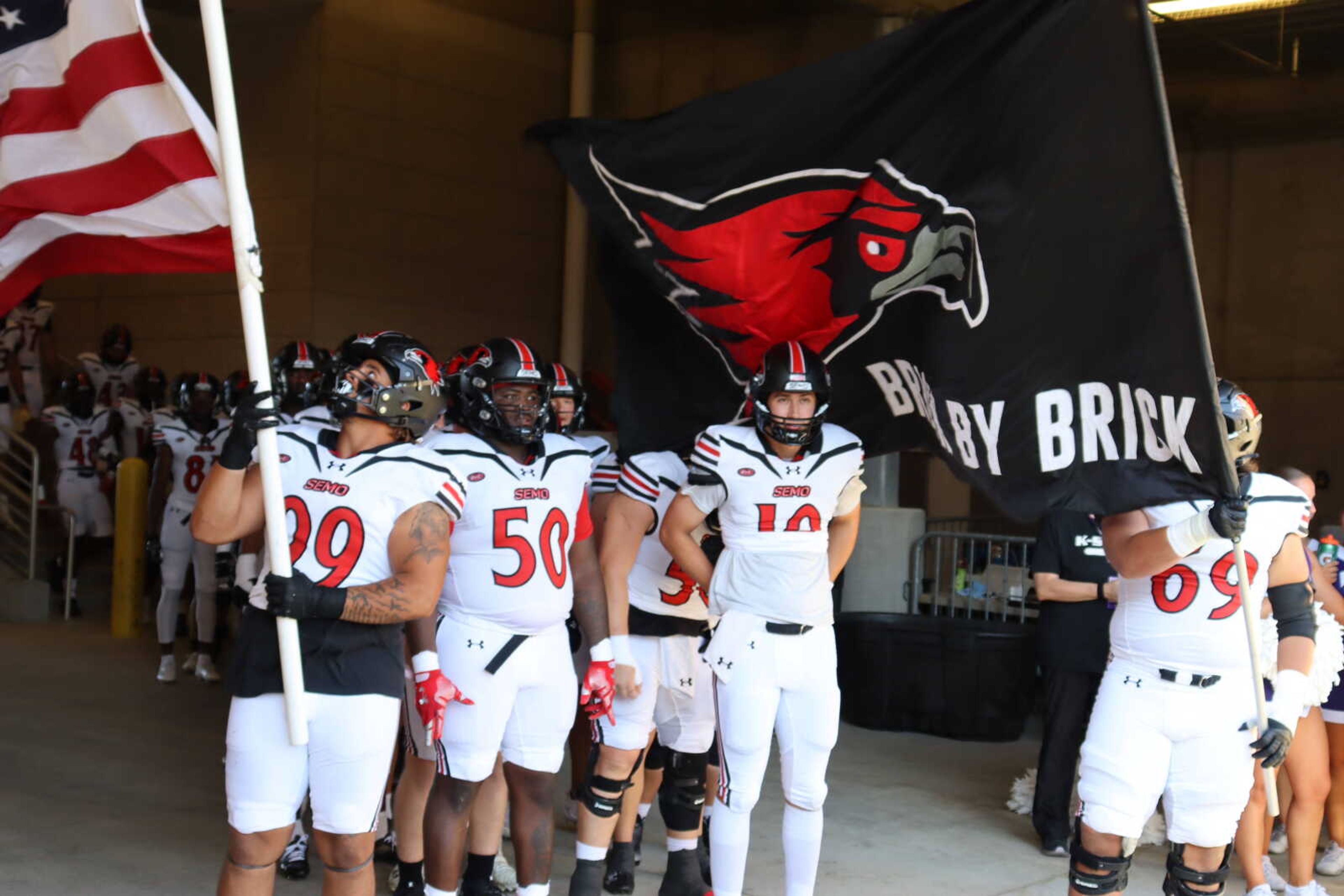 The Redhawks are led onto the field by senior defensive linemen Steven Lewis (99), Lunden Manuel (50),  junior quarterback Paxton DeLaurent (10) and  junior offensive lineman Kobe Sixkiller (69), before losing 45-0 to the Kansas State Wildcats on Sept. 2 at Bill Snyder Family Stadium in Manhattan, KS.