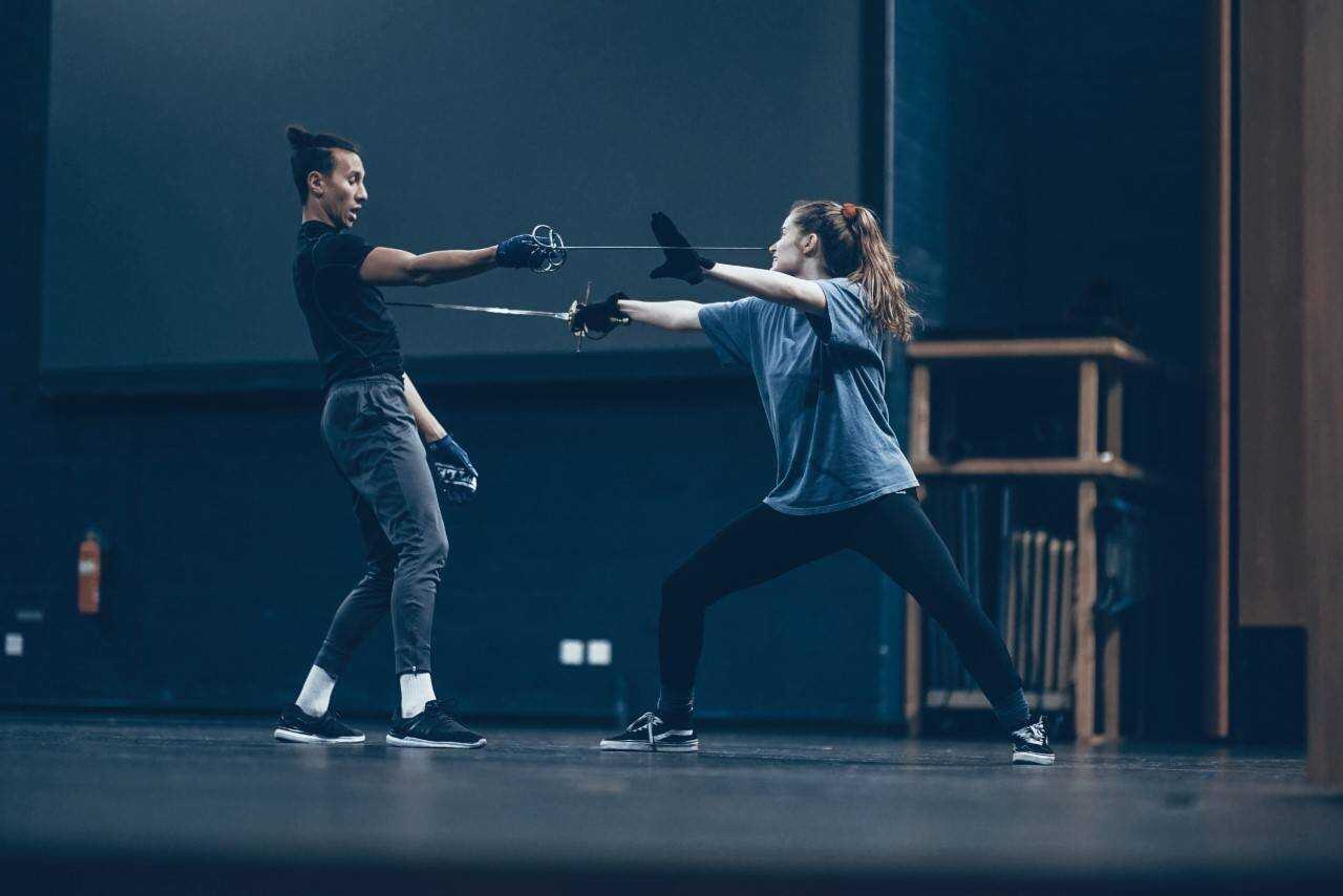 Corie Williams (left) and Alex Burke (right) perform a combat scene during the Dueling Arts International Workshop.