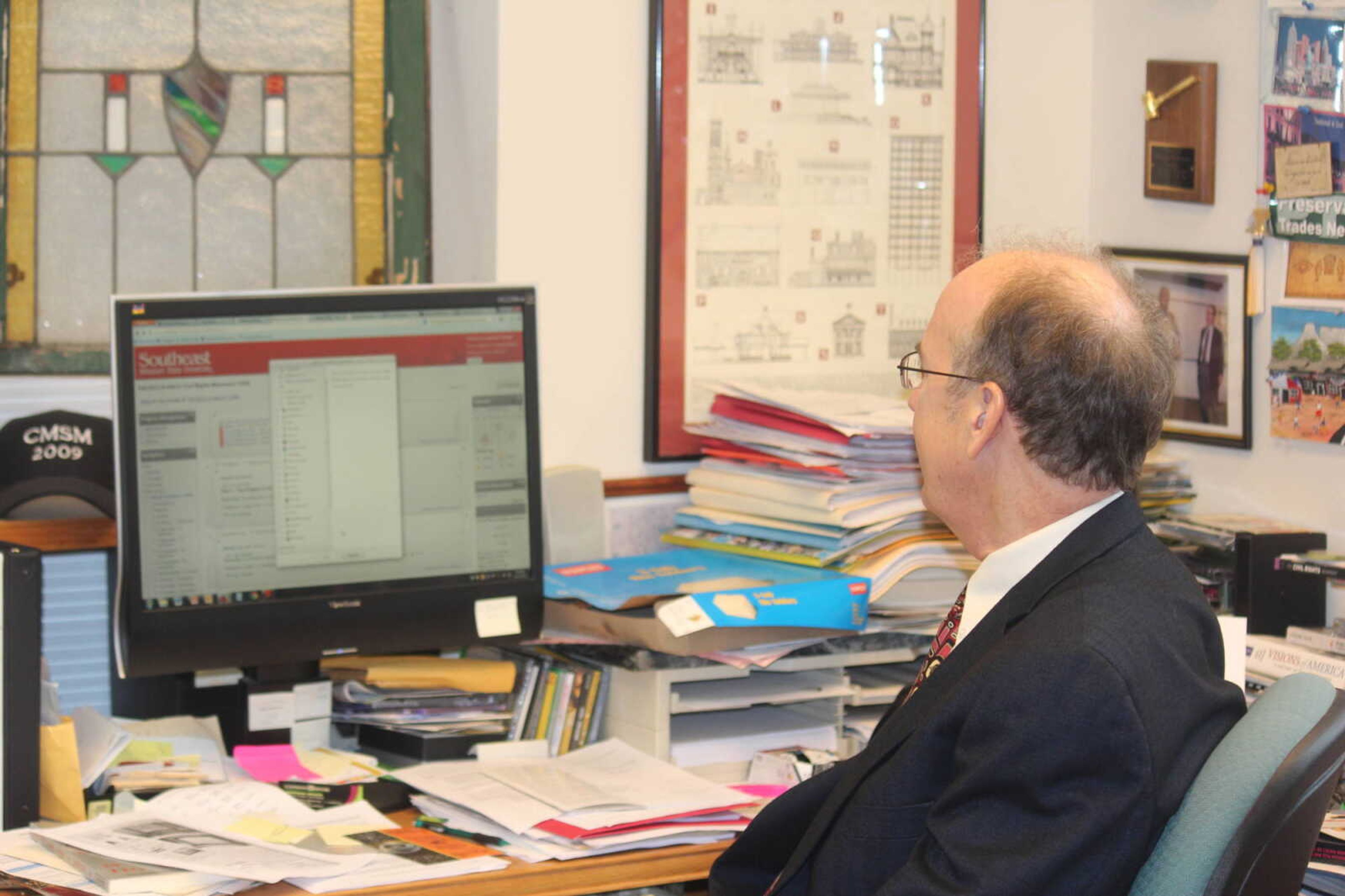 Dr. Steven Hoffmann working with Moodle at his desk. Photo taken by Michael Ryan.