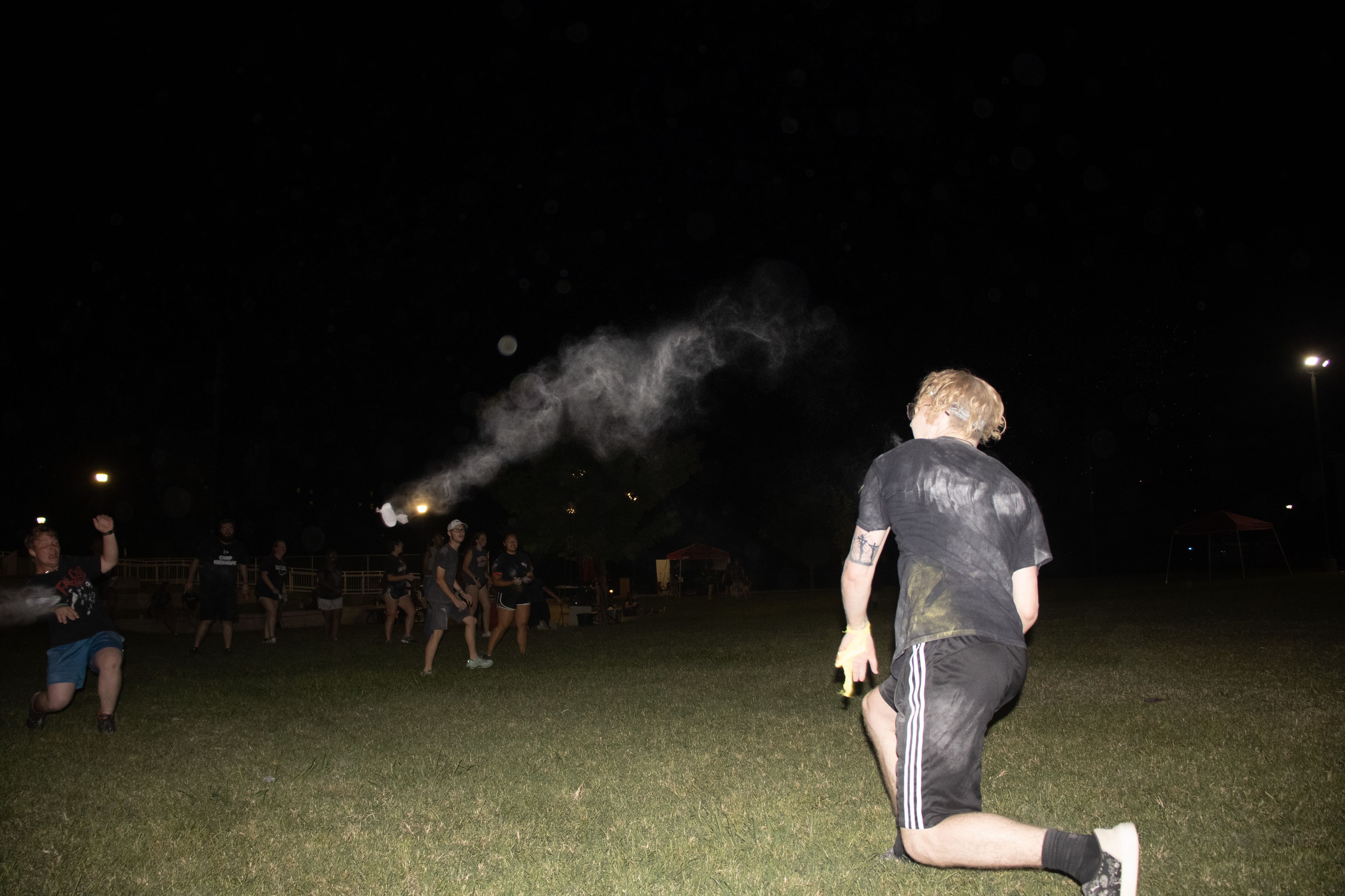 Chi Alpha leader and junior English education major Trevor Thompson throws flour at the opposing team.