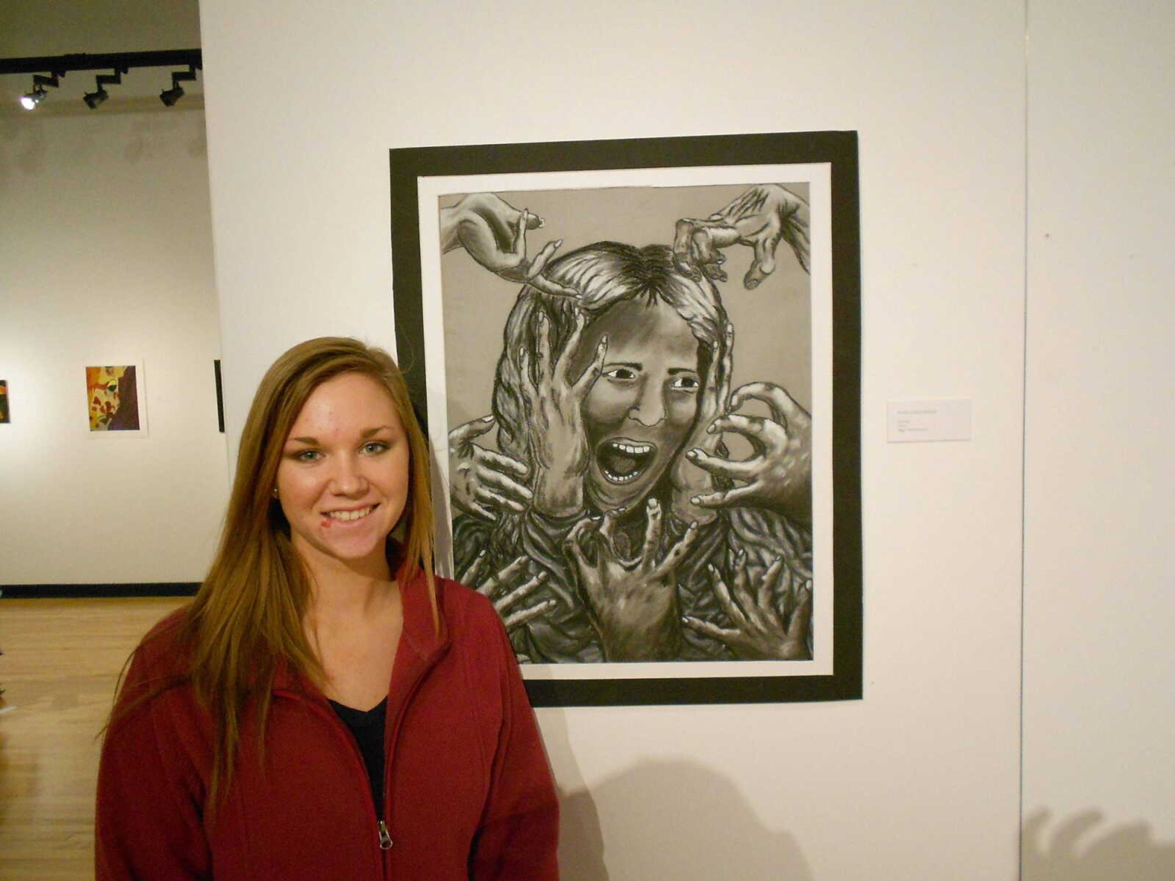 High school students show off their art work at art exhibition