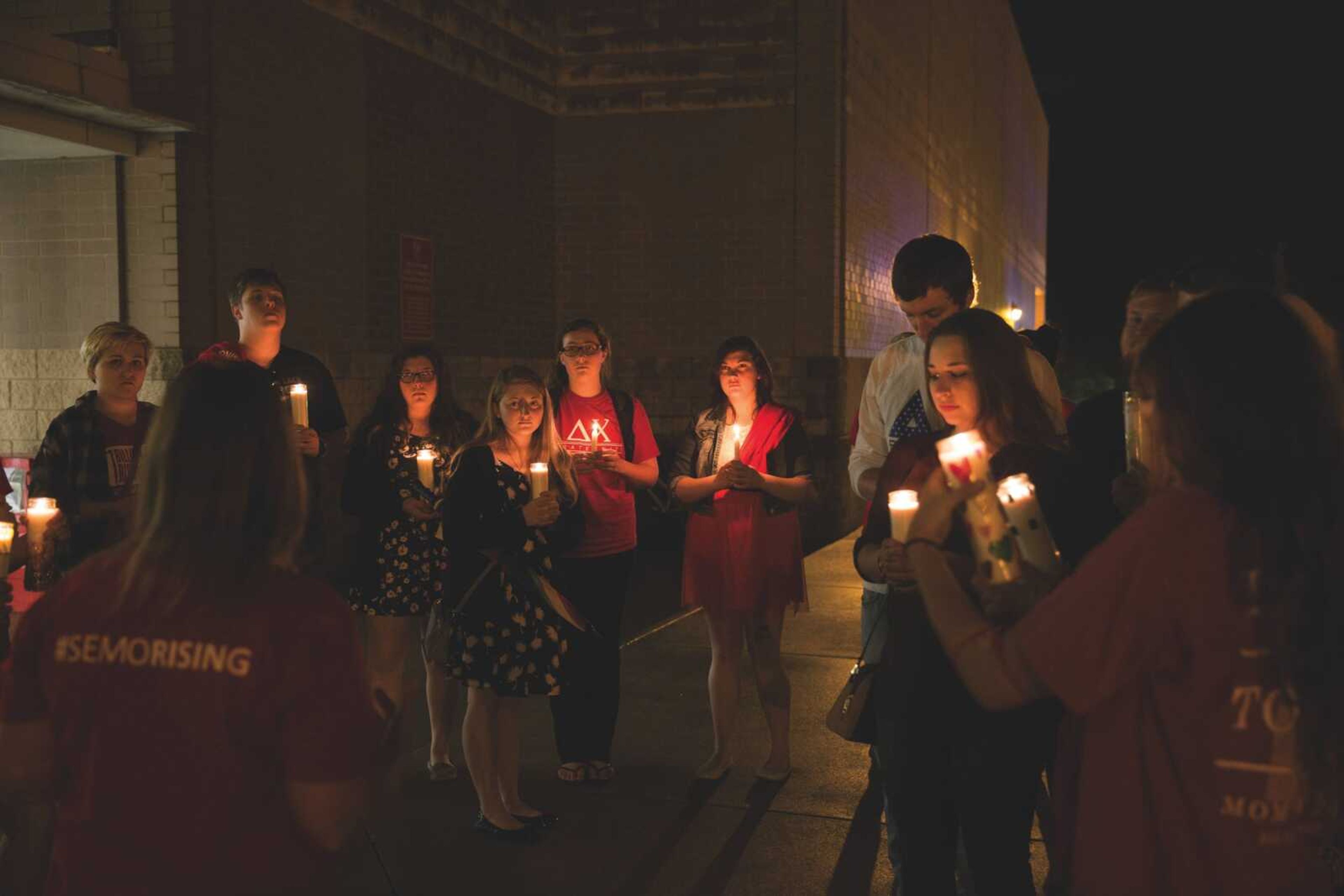 Southeast students stand together at a candlelight vigil on April 21 during SEMO Rising.