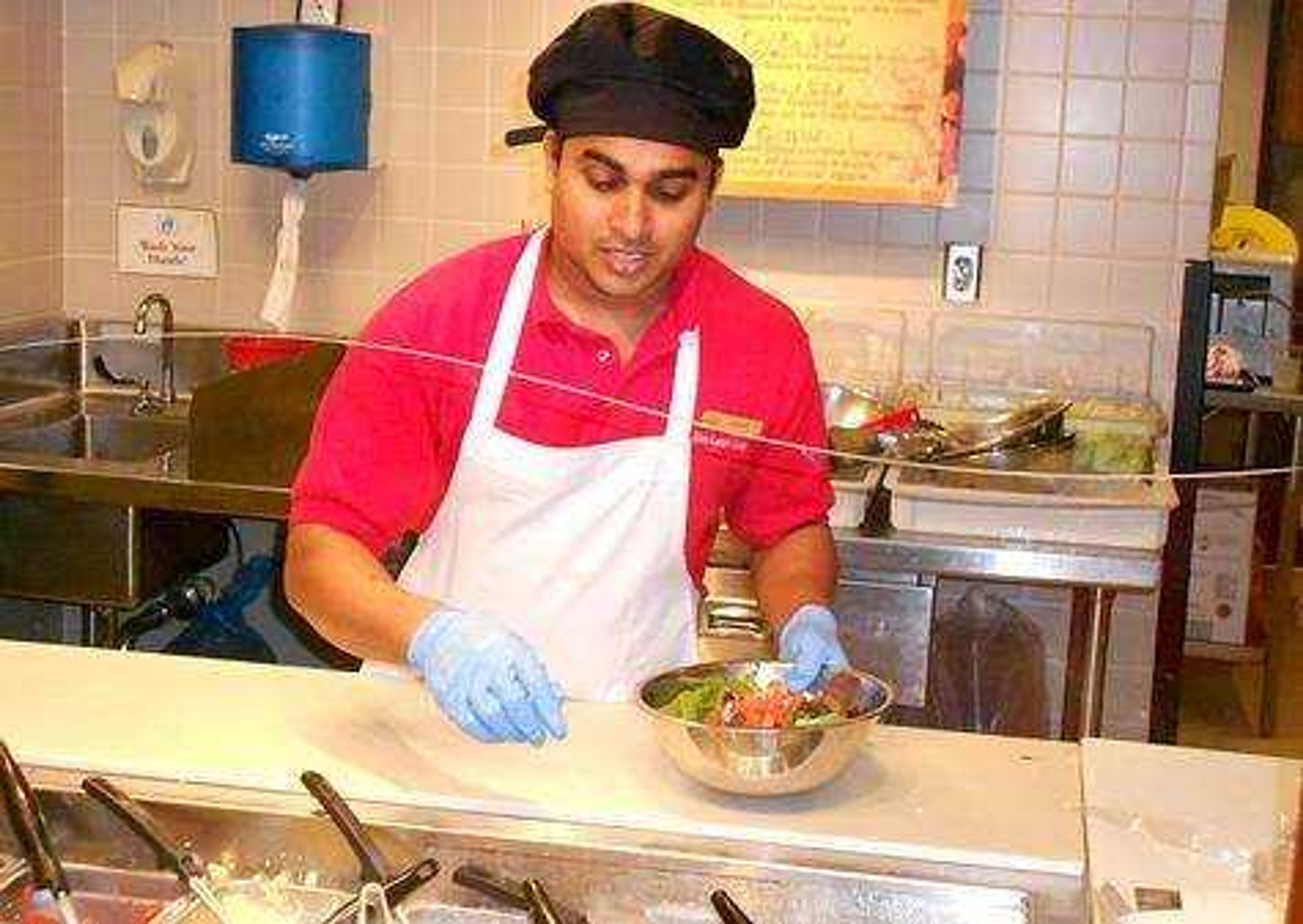 International student and Chartwells employee Rajesh Vemuri prepares a meal. Photo by Kyle Thies