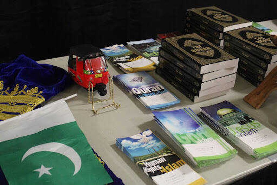 A table holds flags, pamphlets and copies of the Quran. Some of the topics of the pamphlets ranged from human rights in Islam to women in Islam.