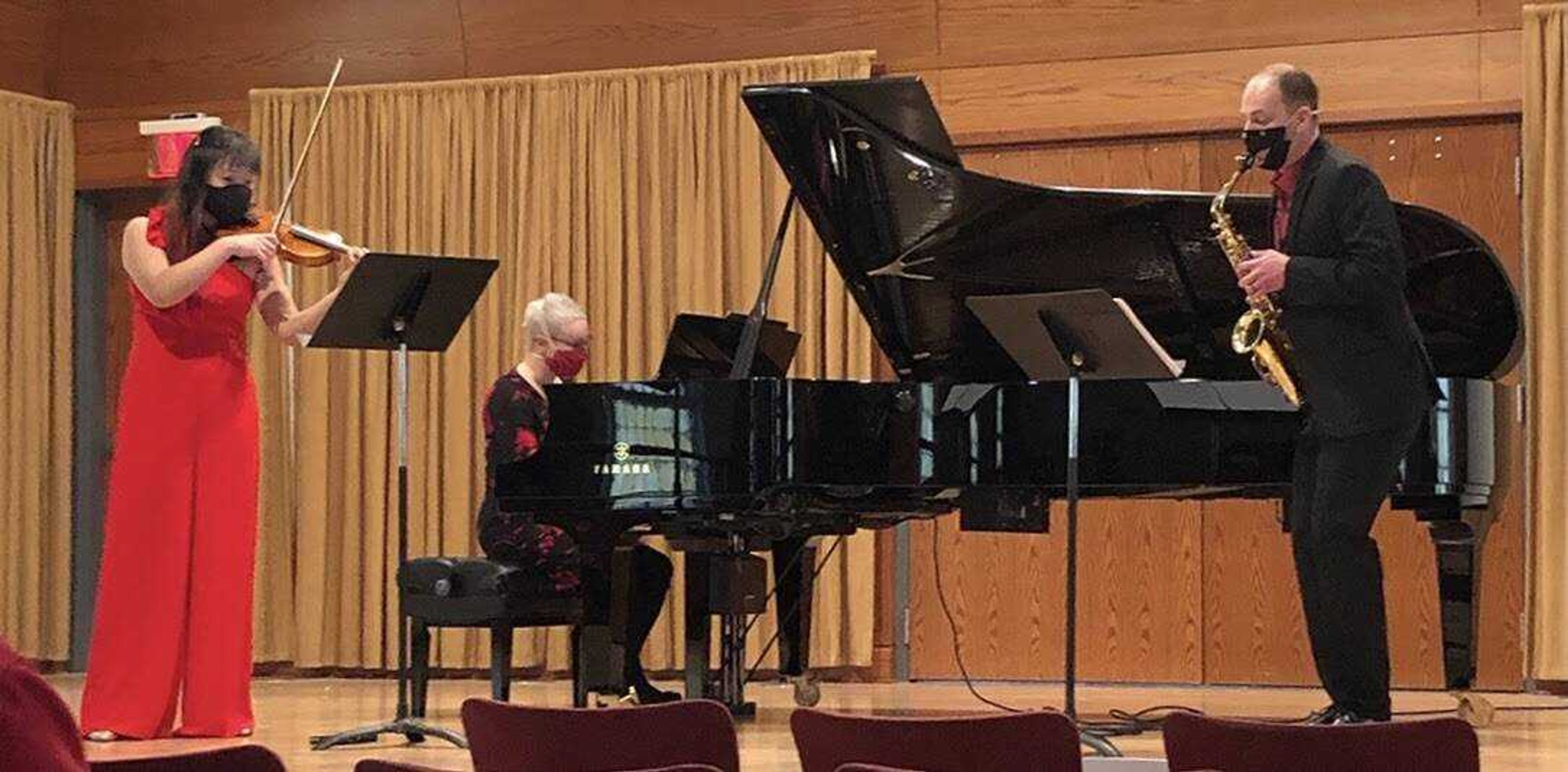 Assistant Professor of Upper Strings and Concertmaster at Southeast Missouri State University Dr. Sophia Han (left), Director of Choral Activities Dr. Barb Lamont (middle) and Assistant Professor of Saxophone Dr. Zach Stern perform a piece from their Valentine’s Day recital.